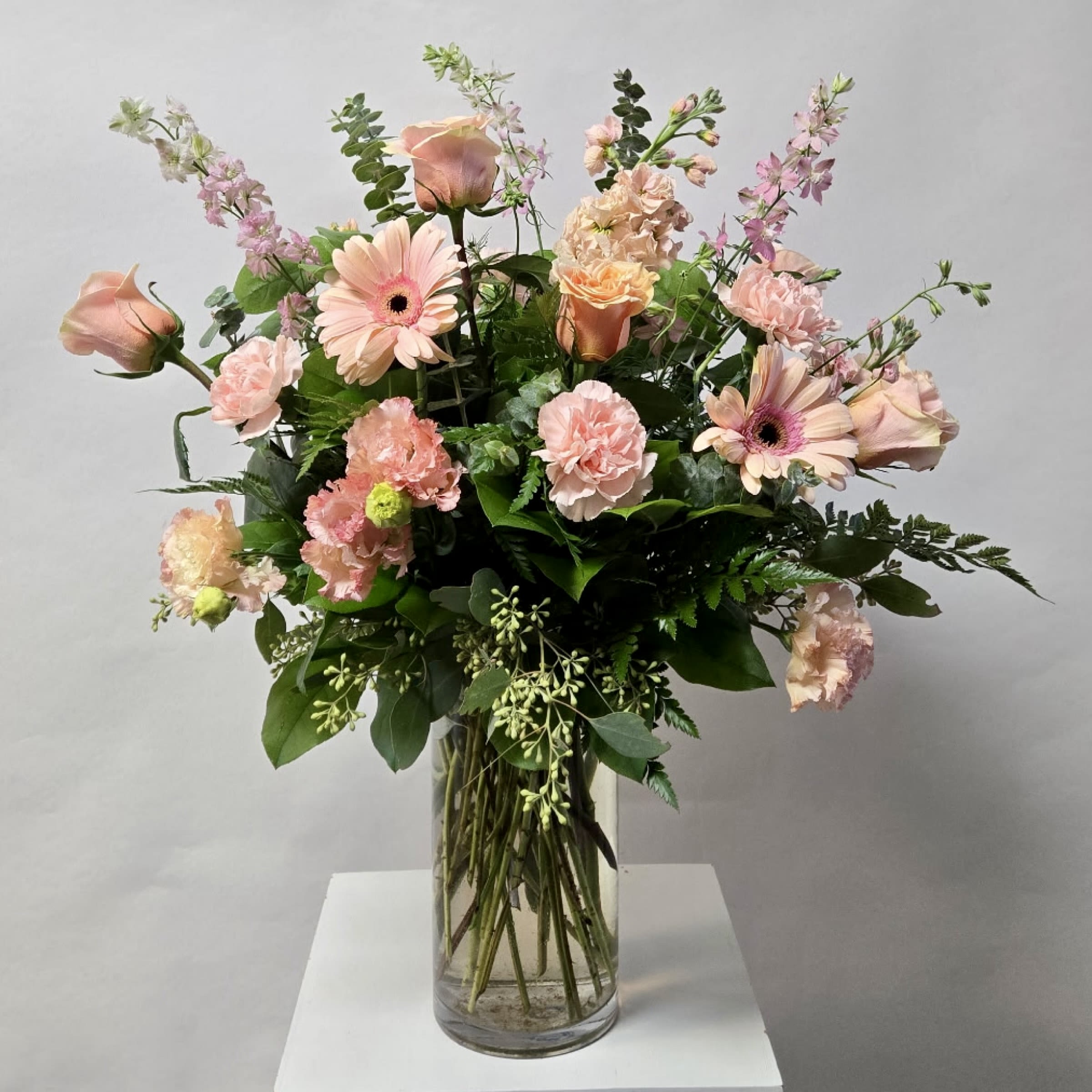 Lady of The House - This Arrangement Includes Gerbera Daises, Roses, Stock, Larkspur, Lisaianthus and Carnations in All Peach and Light Pink Colors. Or as Similar as Possible. 