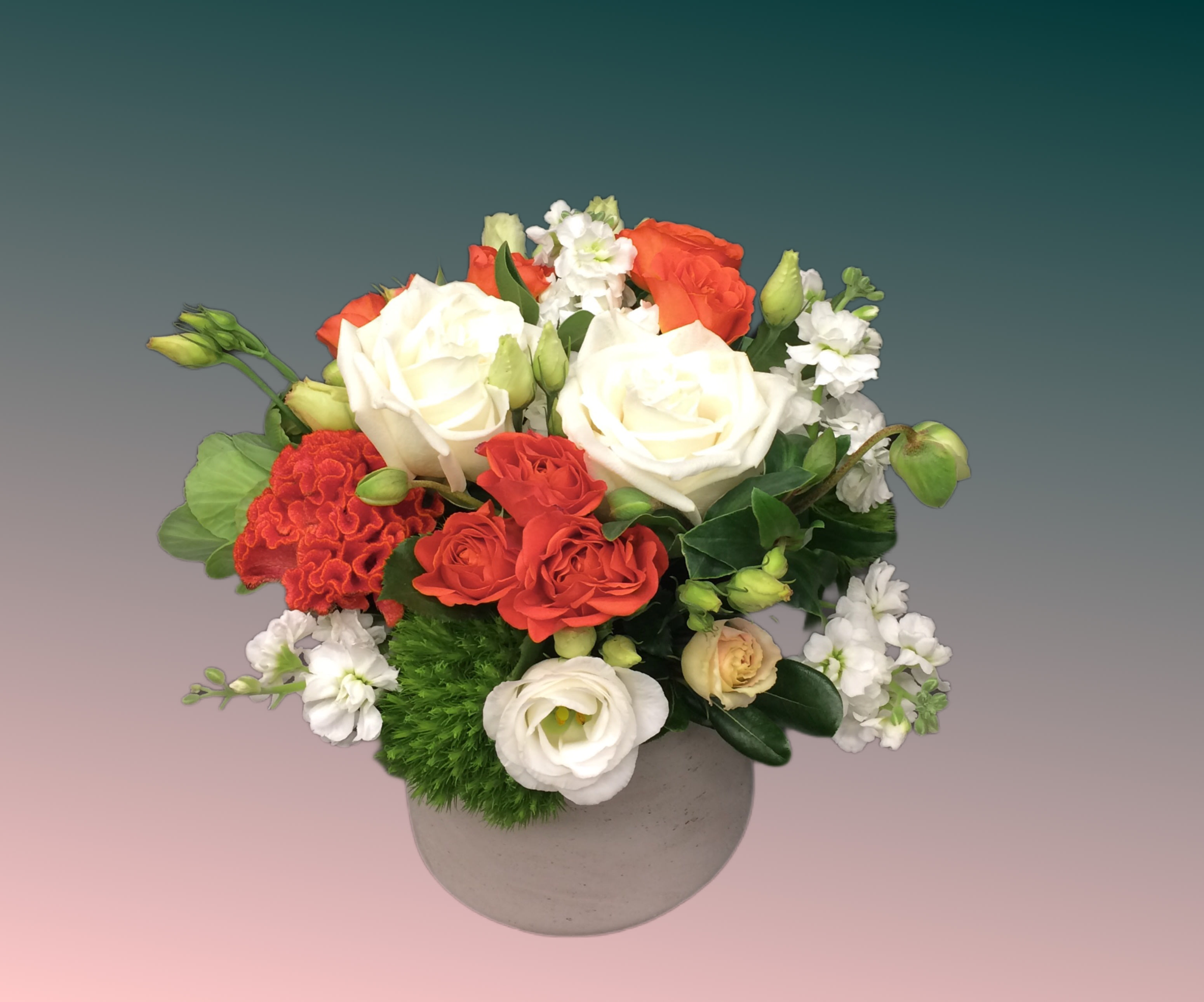 Splash of orange - Orange roses, accented with white stock, lisianthus and green flowers; a touch of late summer
