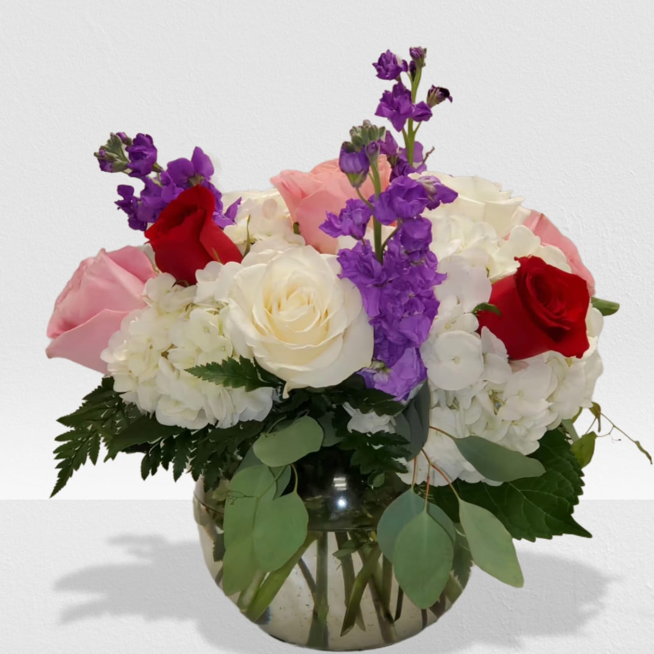 Modern Fairytale Modern Fairytale - Modern Fairytale is the perfect gift for a birthday, show gratitude, or romantic gesture. Arrangement Details: Includes white roses, blush roses, red roses, white hydrangea, purple carnations, red hanging amaranthus, and seeded eucalyptus. APPROXIMATE DIMENSIONS:10" H X 11" W