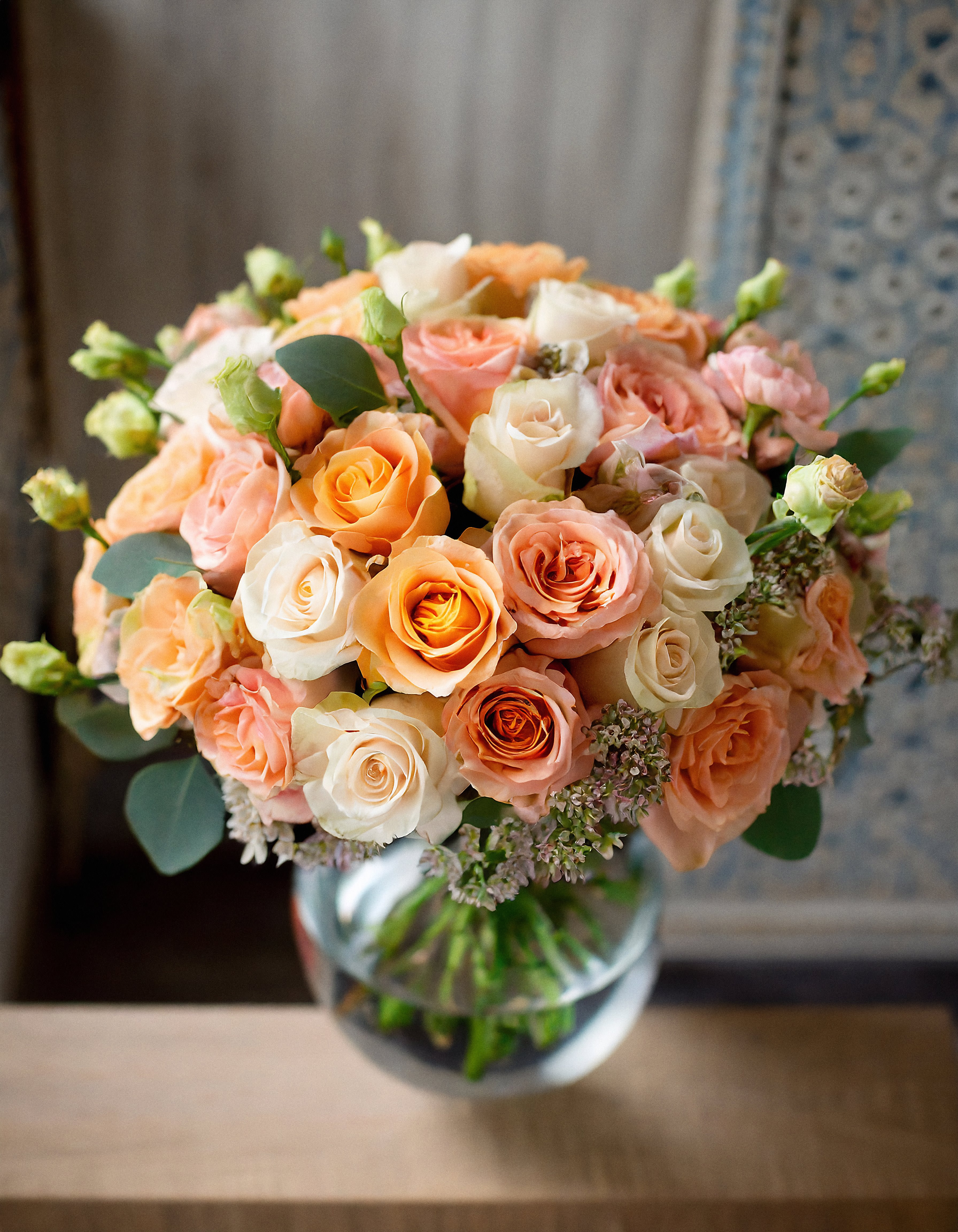 Malibu Sunset - Immerse yourself in the beauty of this flower ensemble, a delicate mix in a light peach palette. The stunning composition is showcased in a clear vase, radiating the warmth of sunshine.  Disclaimer: ALL IMAGES PROVIDED AT DELUXE PRICE Photos and visual presentation of the products represent an overall style, look and feel, which we may not be able to identically replicate in some instances.