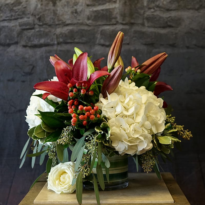 Moonlight Merlot - &quot;Moonlight Merlot&quot; is a striking arrangement featuring rich burgundy lilies paired with lush white hydrangea. Accented with hypericum berries and fresh greenery, this elegant design blends deep, dramatic tones with soft, romantic blooms, perfect for any sophisticated occasion.  