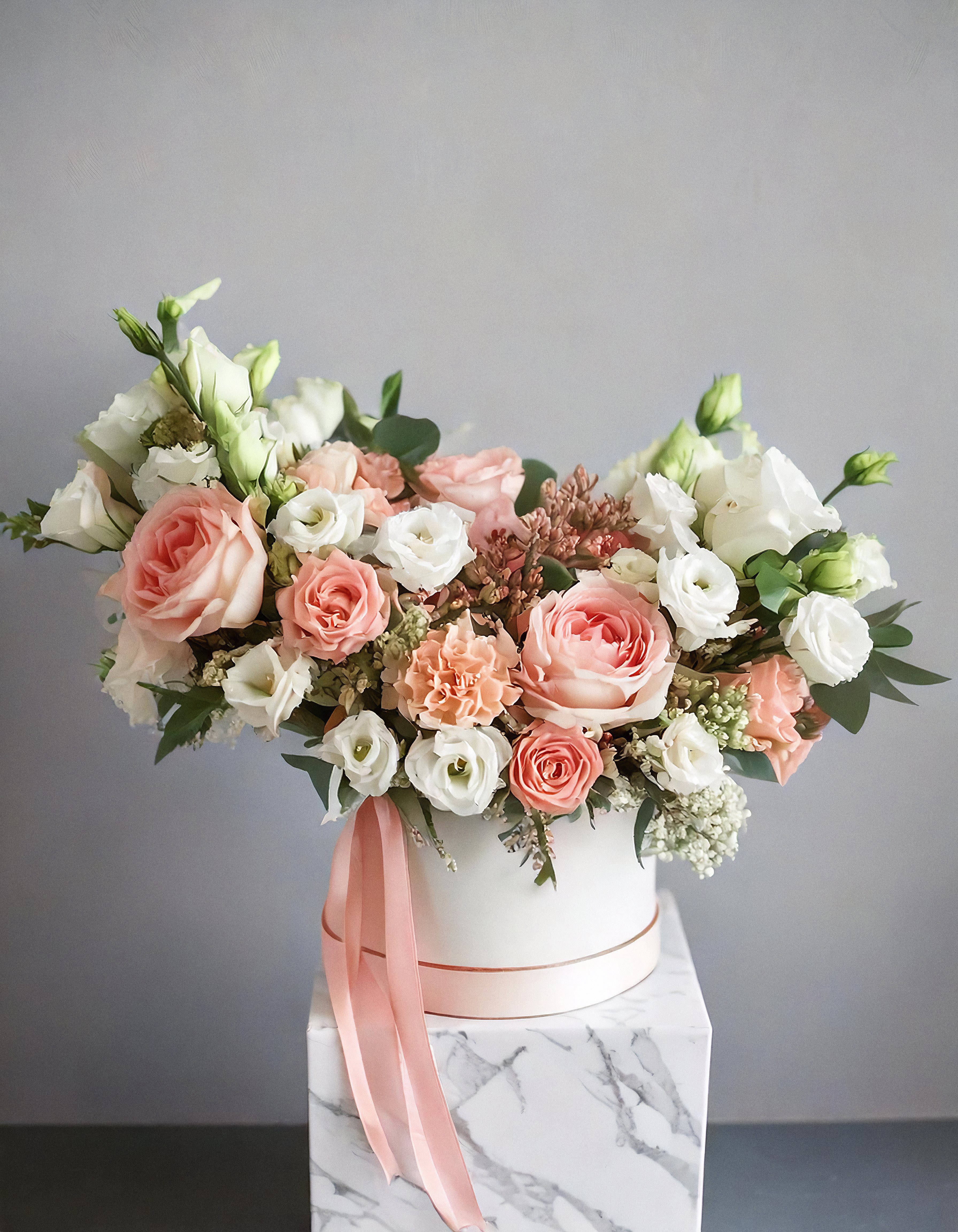 Rosa Beamed - The arrangement features a stunning mix of flowers, including white and peach roses, white lisianthus, creating a harmonious blend of soft and vibrant colors. Whether it's a special occasion or just because.