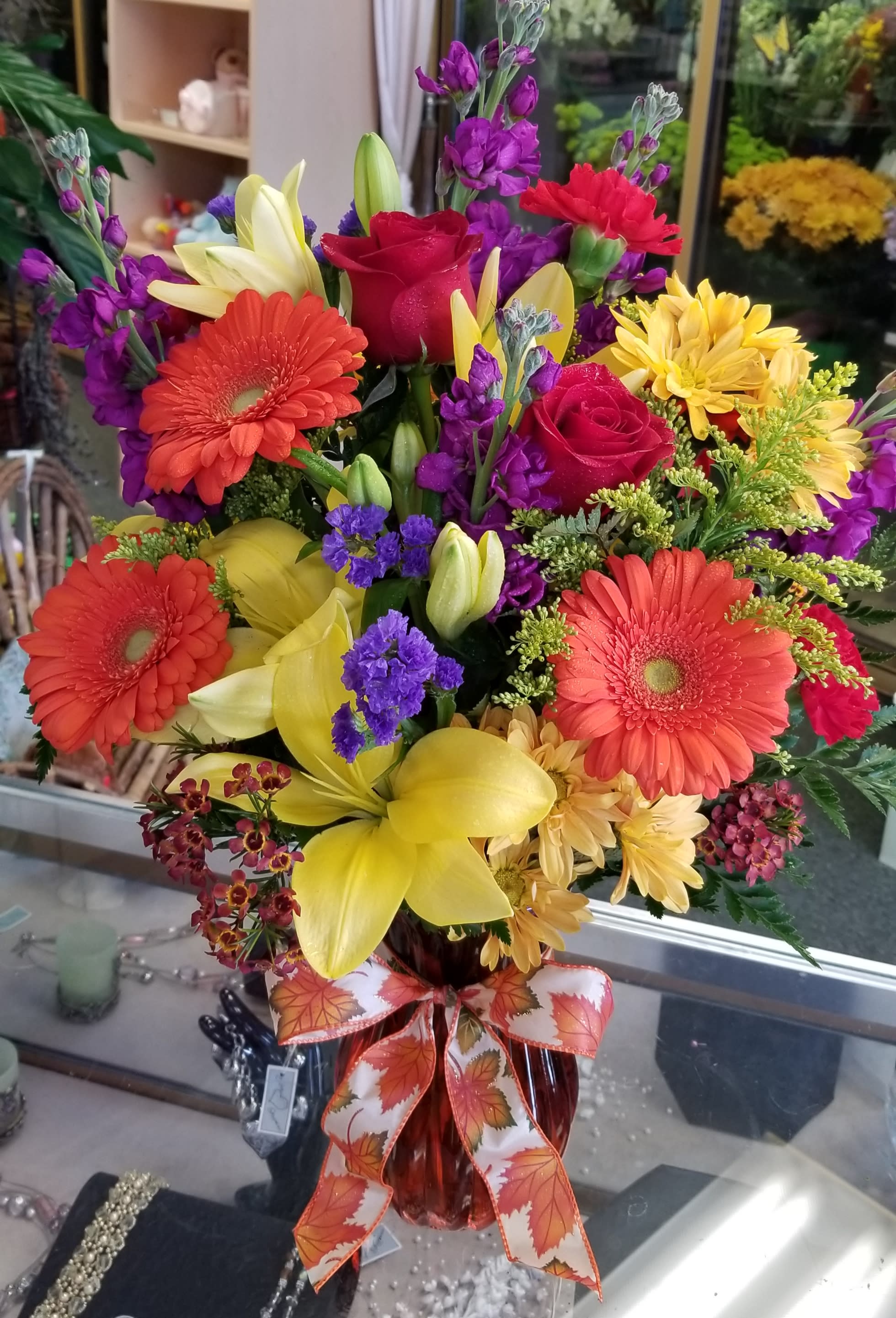 Bright Autumn  - Lilies, roses, gerbera daisies, stock, statice, solidago, daisies, and wax flower.