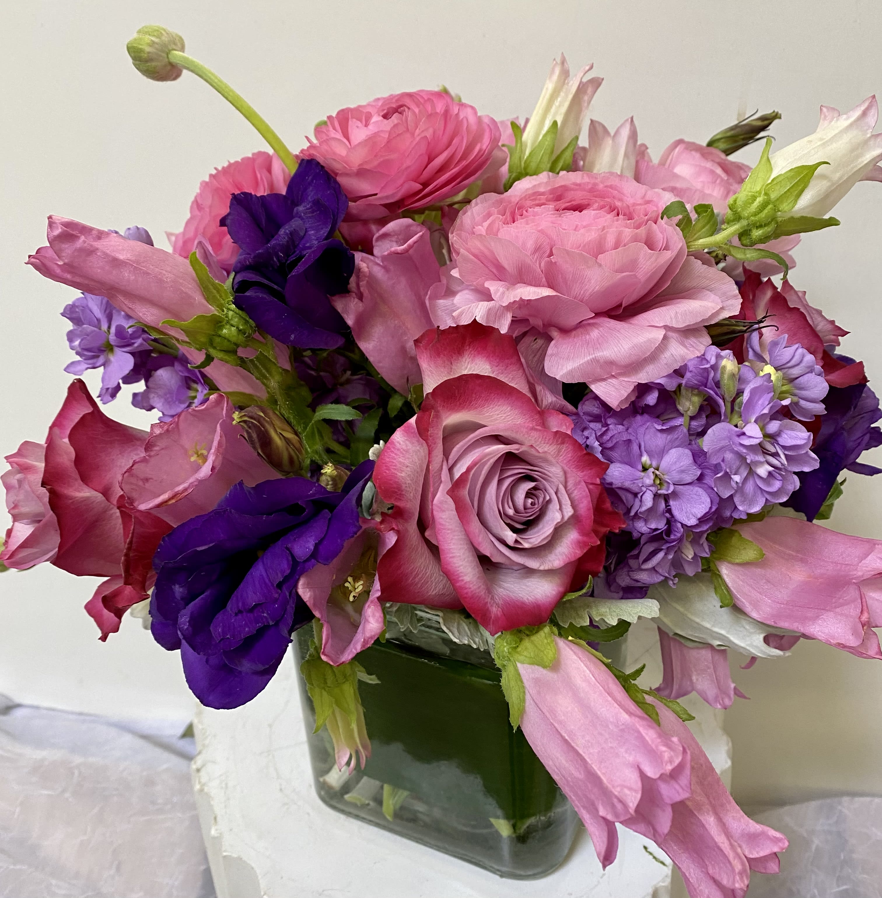 In the Mood for Love - Clear glass vase with a purple lisianthus, purple roses ,lavender stock , pink roses 