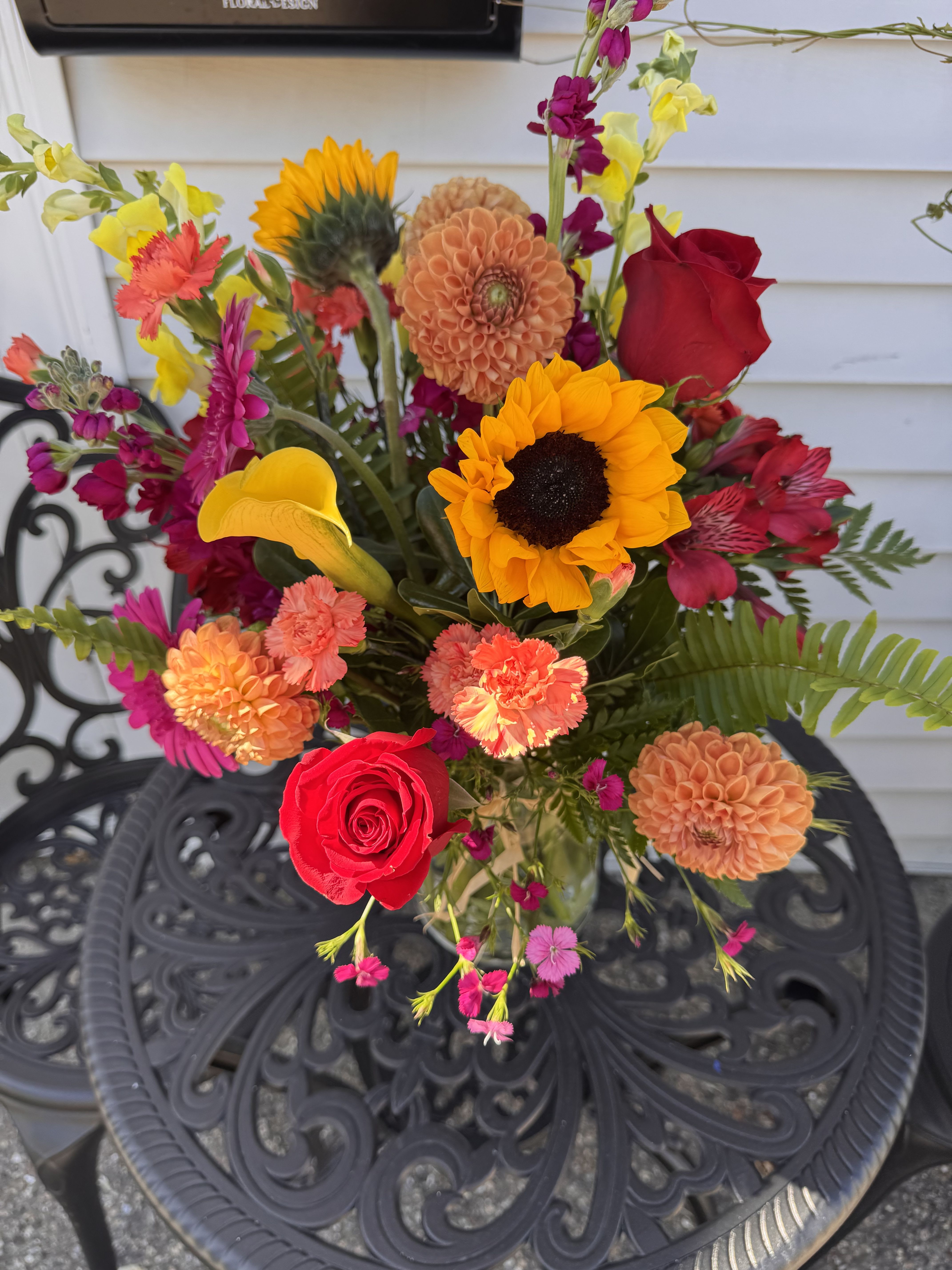 Indian Summer - Tall arrangement filled with bright tones of oranges, yellows and deep pinks