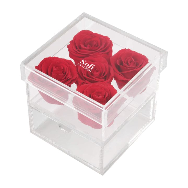 Crystal Bloom - Crystal Bloom – Preserved Roses in Acrylic Box Elegance meets functionality with Crystal Bloom, a stunning arrangement of 5  preserved Ecuadorian red roses encased in a sleek acrylic box with a hidden drawer that doubles as a jewelry box. Part of our luxurious collection at Sofi La Fleur, this design is perfect for gifting or adding a sophisticated touch to any space.  Symbolizing everlasting love and beauty, Crystal Bloom is ideal for anniversaries, birthdays, or as a romantic keepsake. Order now from Sofi La Fleur for a gift that’s as practical as it is beautiful.