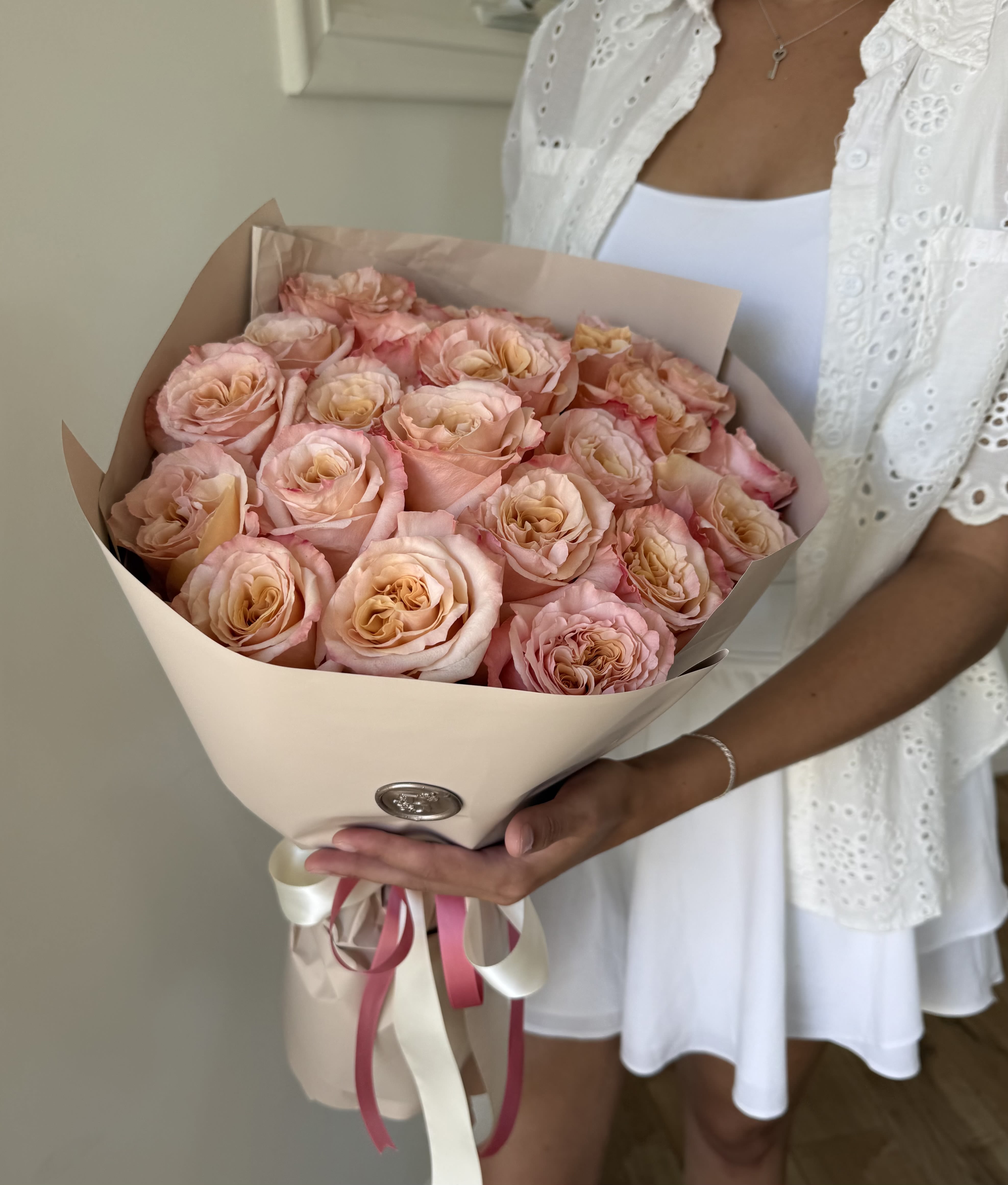 Pink Sorbet - A fresh and elegant wrapped bouquet of roses with soft pink petals and warm sunset centers, creating a clean, vibrant look perfect for any occasion.
