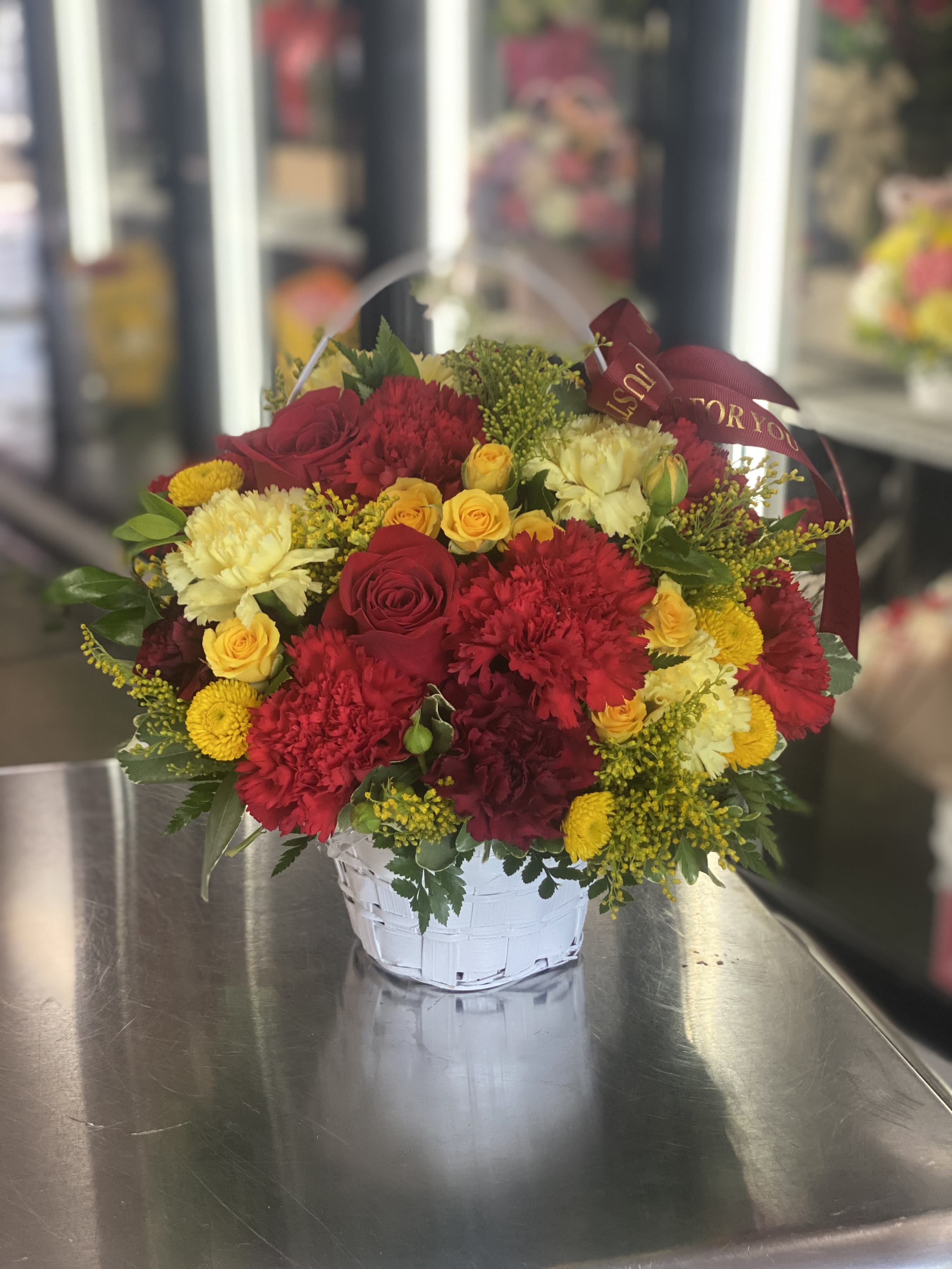 5” Small Basket; Reds/Yellows - Our smallest Basket of 5” of an opening is filled with carnations, pompoms and roses.  Please let us know if you would like soft colors, bright colors, red colors, etc. in the instructions during checkout. 
