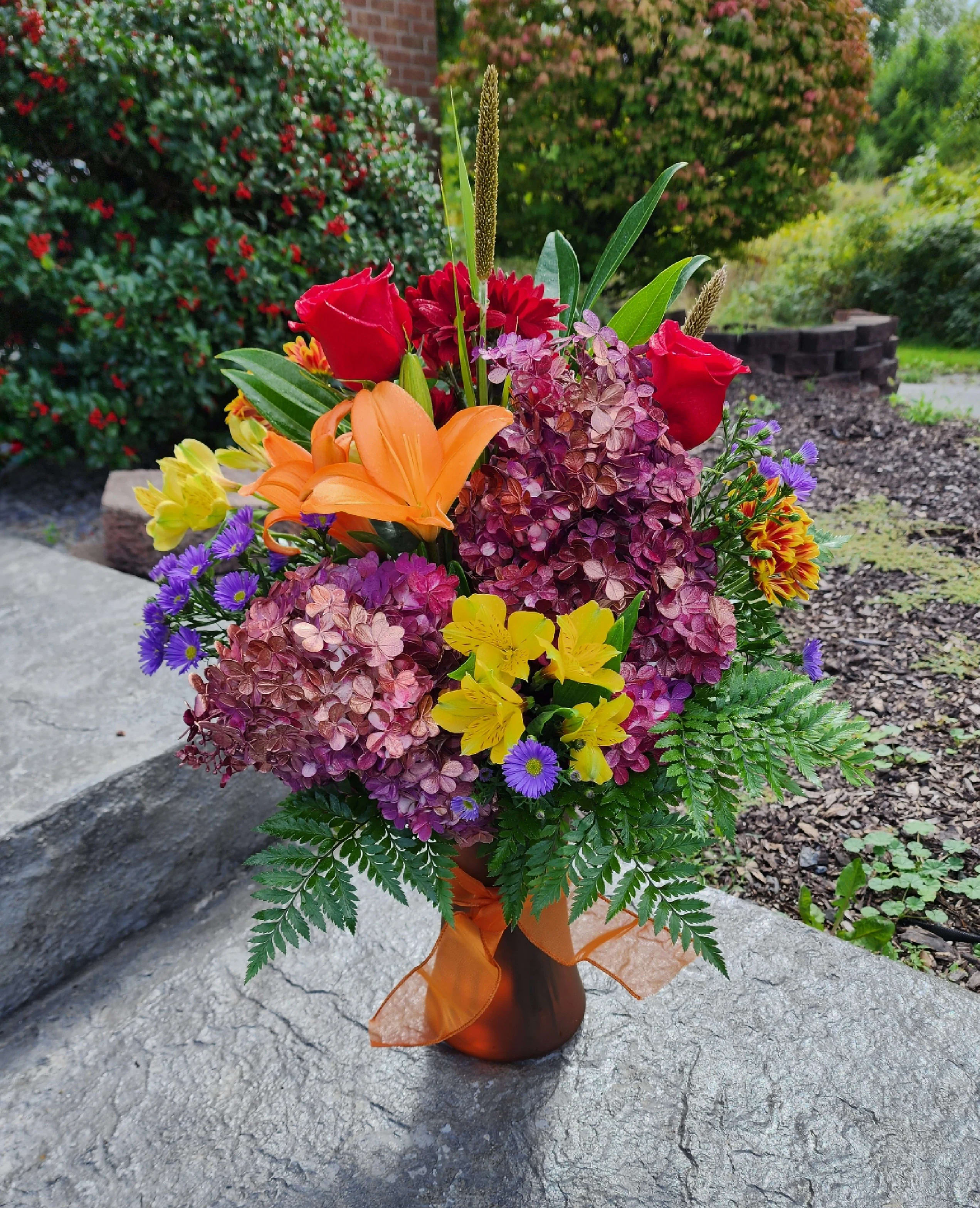 Sunset Blooms by MG Florist Sunset Blooms by MG Florist - A perfect fall bouquet for any occasion. Featuring jewel toned hydrangeas, alstroemeria, roses, lilies, assorted daisy mums and monti casino.