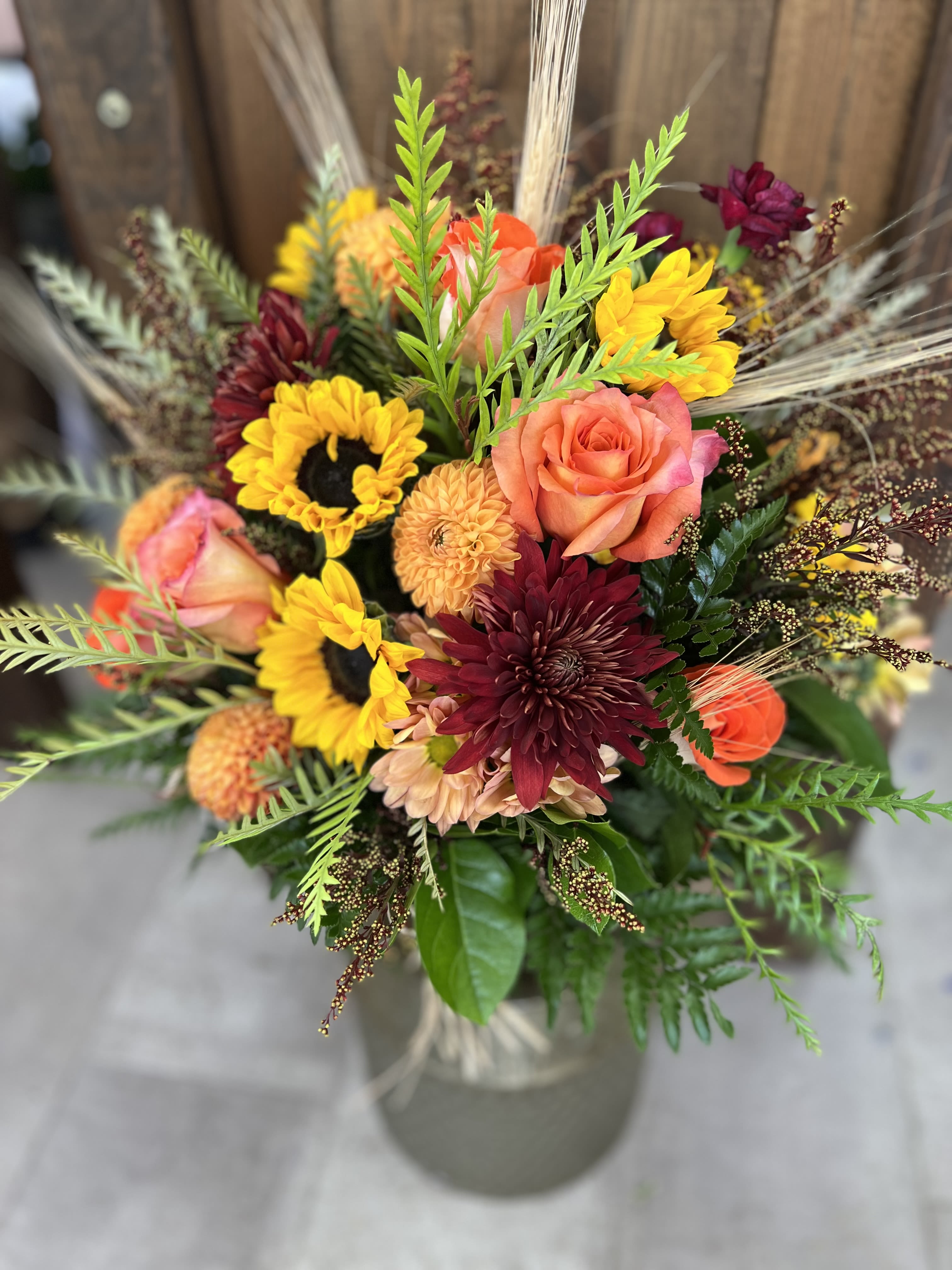November Rain November Rain - A vibrant fall flower arrangement featuring rich oranges, deep reds and golden yellows. Roses, Sunflowers and Dalhias bring a warmth and beauty evoking the essence of the season.