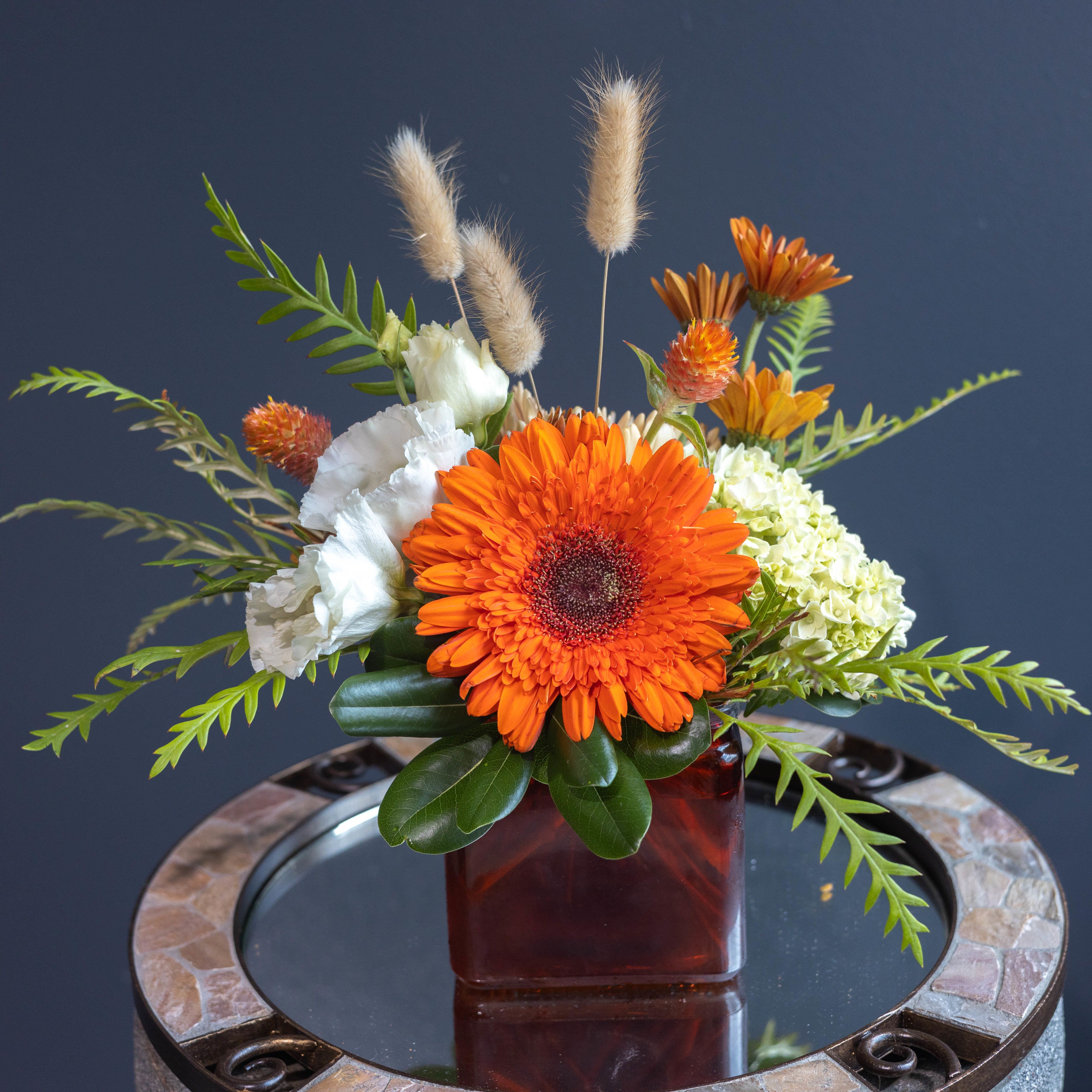 Dreamsicle - A fun end of the summer treat that continues to satisfy the sweet tooth for flowers and helping the lingering outside warmth going into fall! Dreamsicle is made with a variety of farm flowers grown at RDS Farms in an orange cube vase!