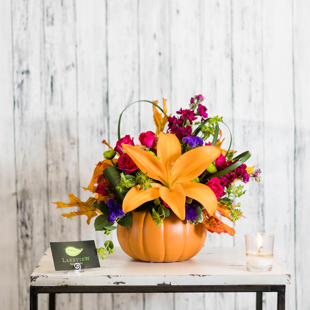 Spooktacular Spooktacular - A unique combination for a bright fall! Lilies, spray roses and statice fill this cute ceramic pumpkin container that can be used again and again. Approximate Dimensions: 13" x 11" W