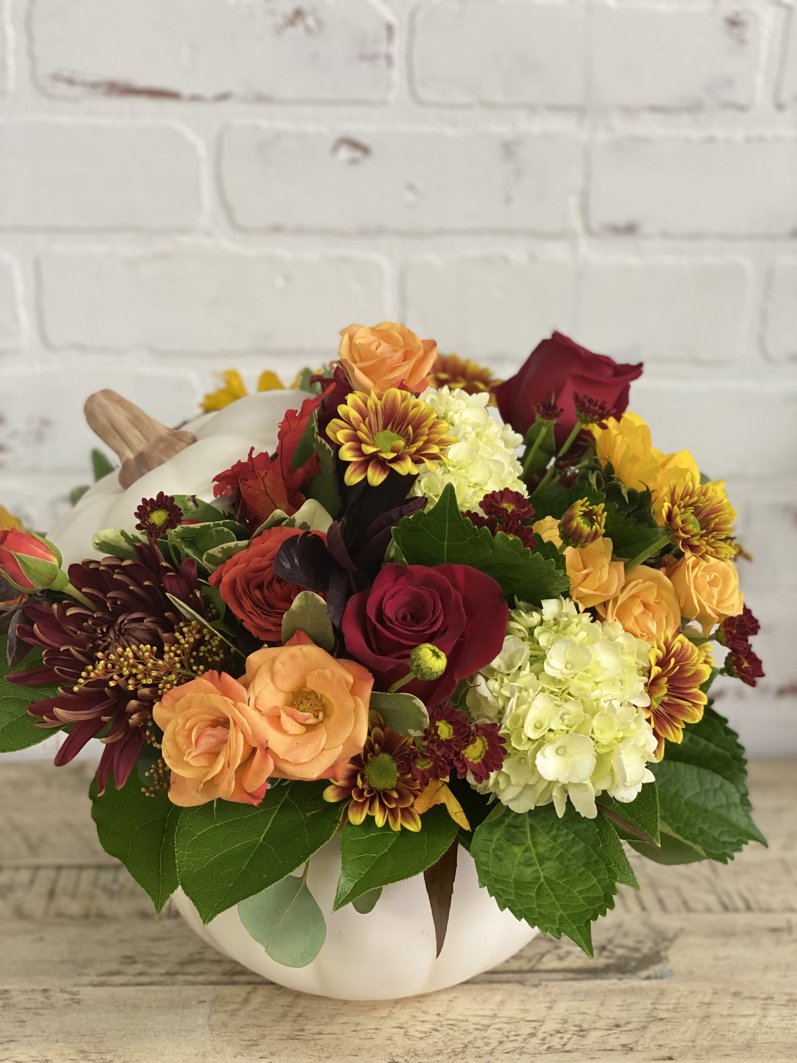 The White Pumpkin - Fall flowers arranged in a white ceramic pumpkin