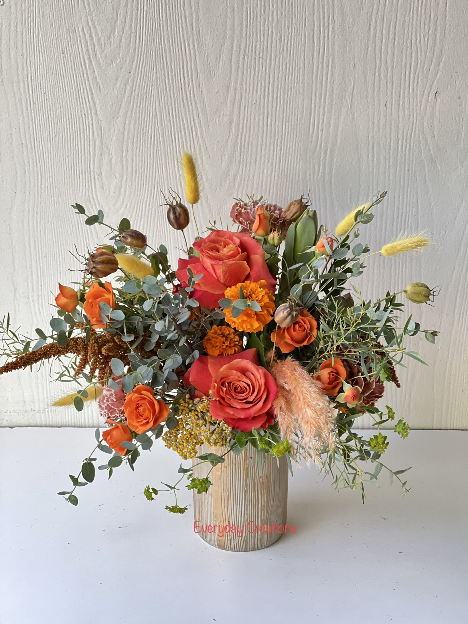 EC-98 Fall Burst Bouquet EC-98 Fall Burst Bouquet - The Fall Burst Bouquet is a gorgeous tribute to the beauty of autumn! This charming arrangement features a beautiful mix of roses, spray roses and other fall-inspired accents and textures, arranged in a stunning gold cylinder vase. The textures and colors wil bring the fall season into your or your loved one's home and is perfect for any seasonal occasion.