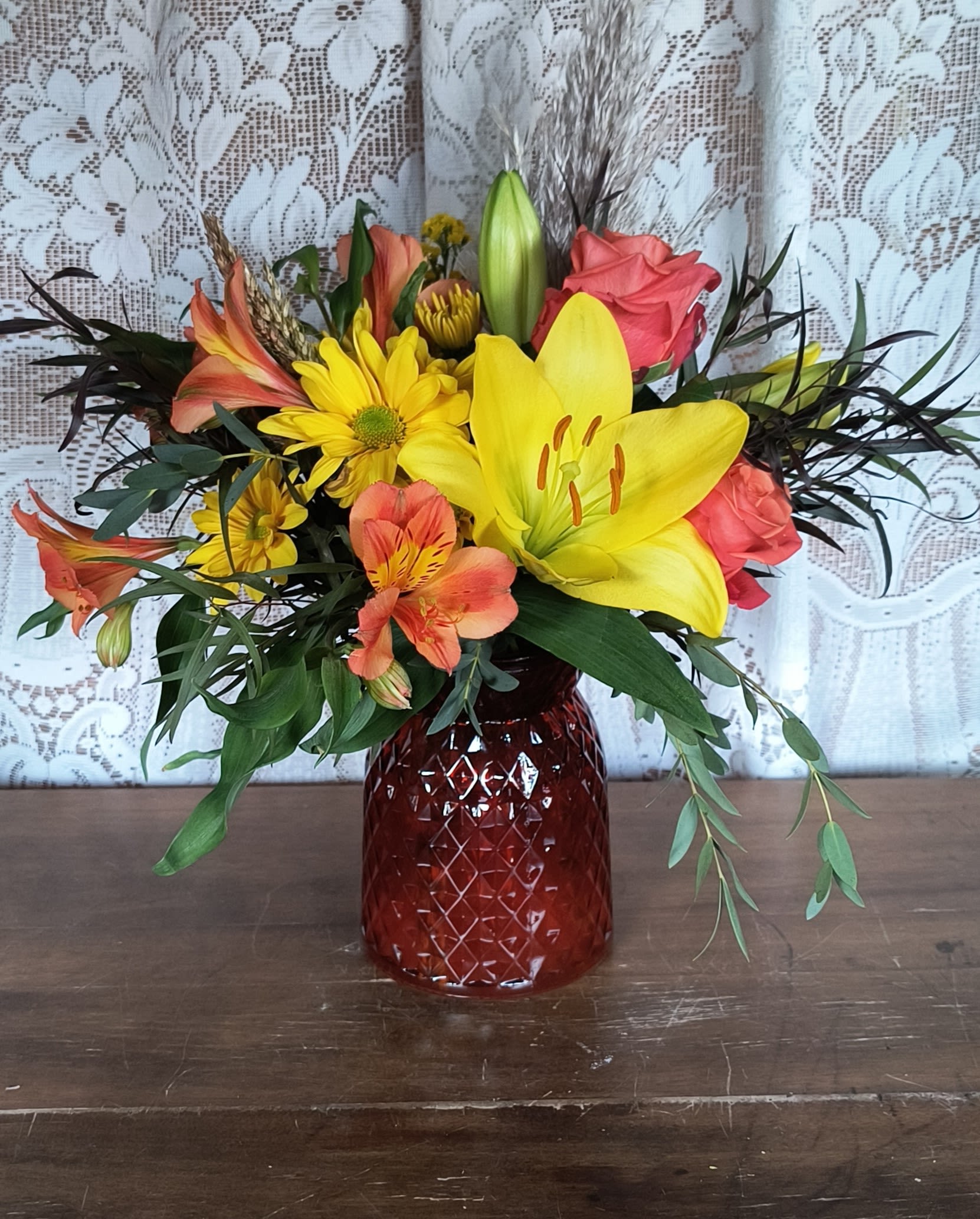 Autumn Vibes - A crisp autumn mix of daisies, lilies, roses, and alstroemeria with added grasses in a seasonal vase. 