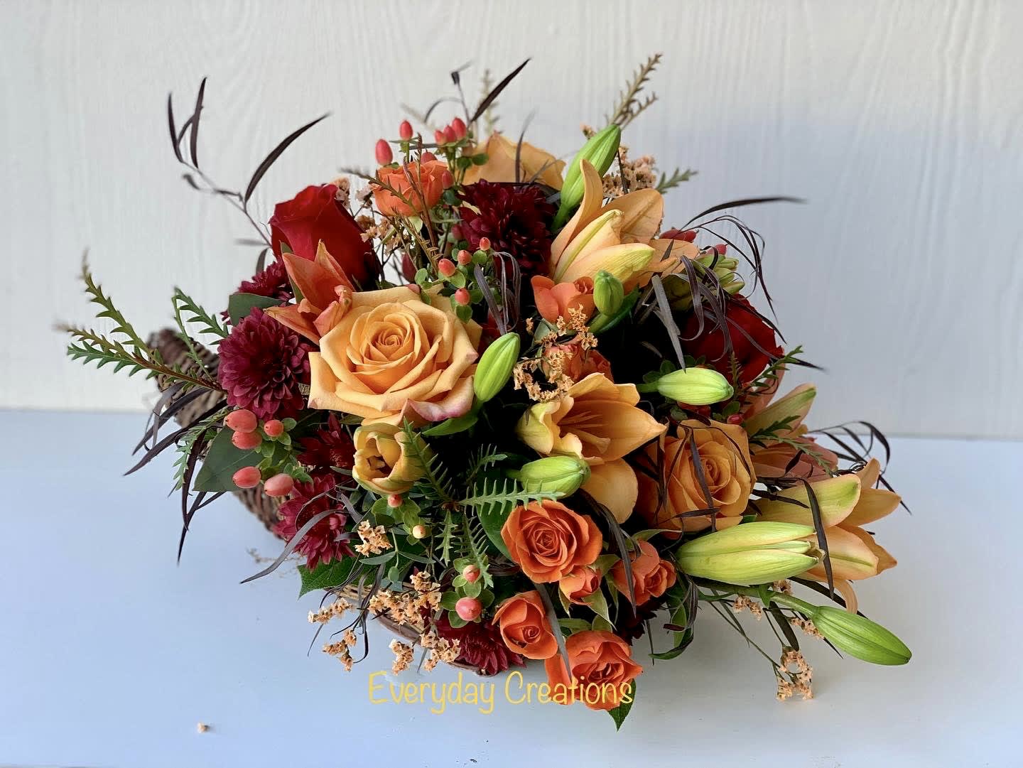 Harvest Cornucopia - our Harvest Comfort Cornucopia shares every message of gratitude during Thanksgiving. A natural, woven cornucopia is filled to the brim with orange roses, Asiatic lilies, fall pompons and glycerized oak leaves. Make their day and delight their home with our stunning Autumn arrangement. 