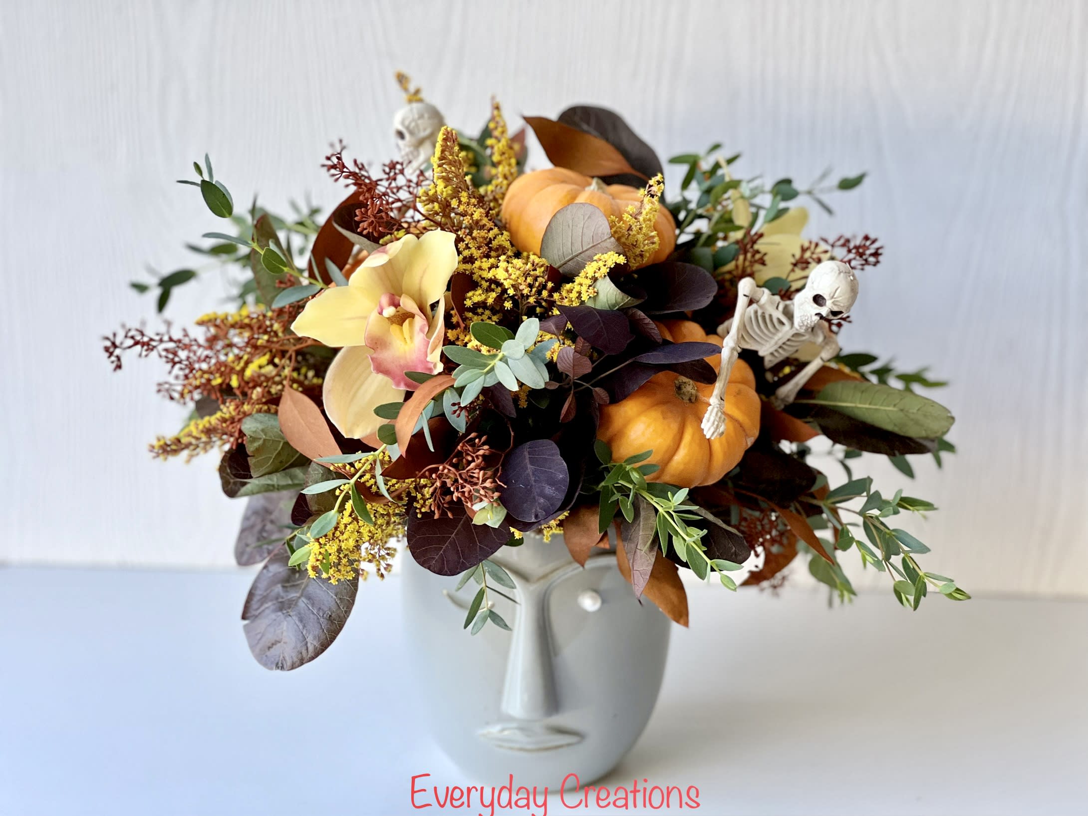 Spooky Harvest Bouquet Spooky Harvest Bouquet - Get into the Halloween spirit with the Spooky Harvest Bouquet - the perfect arrangement to spookify your decor. This stunning bouquet features beautiful cimbidium orchids, a variety of fall foliage, miniature pumpkins and even a few skeletons to add a playful touch. Arranged in a unique gray portrait vase, this haunted yet delightful bouquet is the perfect Halloween statement piece for your home or office. Whether you're hosting a party or simply want to get into the Halloween spirit on your own, the Spooky Harvest Bouquet has everything you need.