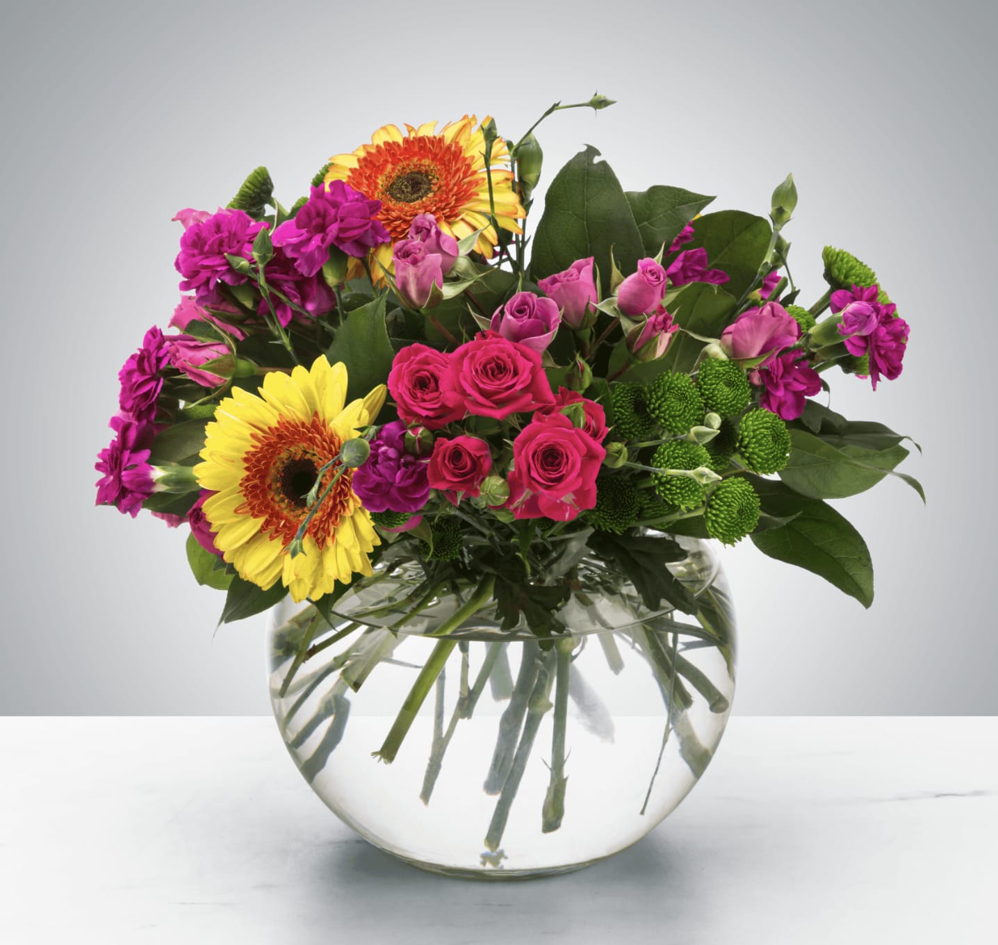 Jill - A bright bubble arrangement featuring button mums, gerbera daisies, and spray roses, this arrangement makes a lovely thank you or just because gift.  Approximate Dimensions: 12''D x 12''H