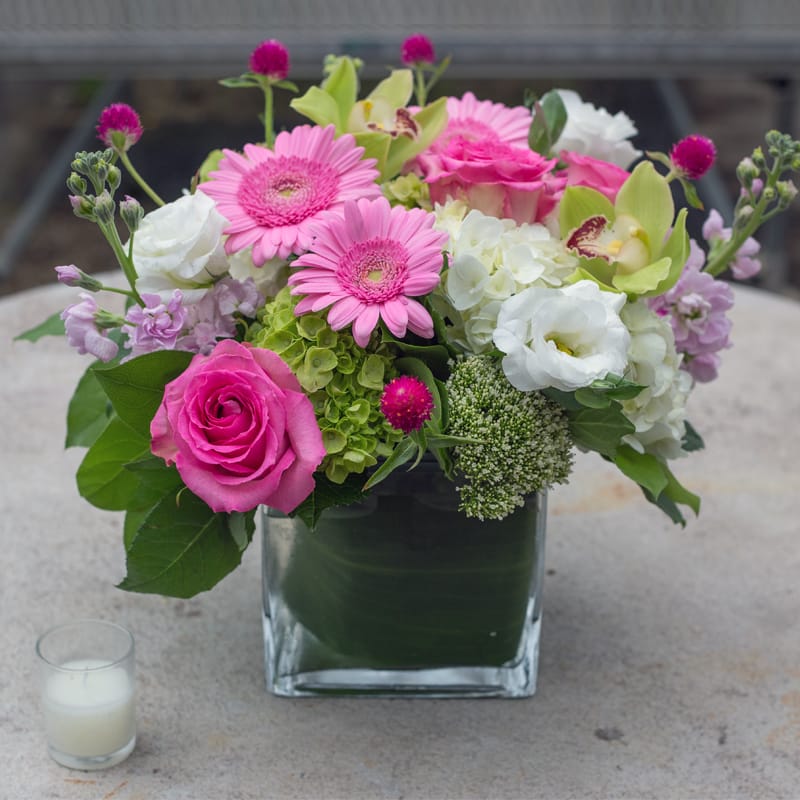 Wonderful Delight  - Gerberas, lisianthus, gumfina, hydrangeas, lemon leaf, and a sweet unique rose in a large square glass vase. 