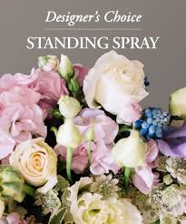 Designer's Choice Funeral Arrangement - Easel Spray - Send a sympathy floral standing spray created by one of our floral experts. Seasonal flowers are arranged in this beautiful gift to show your care and concern; pastel roses, lilies, mums, snapdragons and more. You can get in pastel shades, bright and colorful, or in all white flowers. Standing sprays are an appropriate gift for delivery from a family member, friend or co-worker. Delivery is available directly to a funeral home or places of worship.