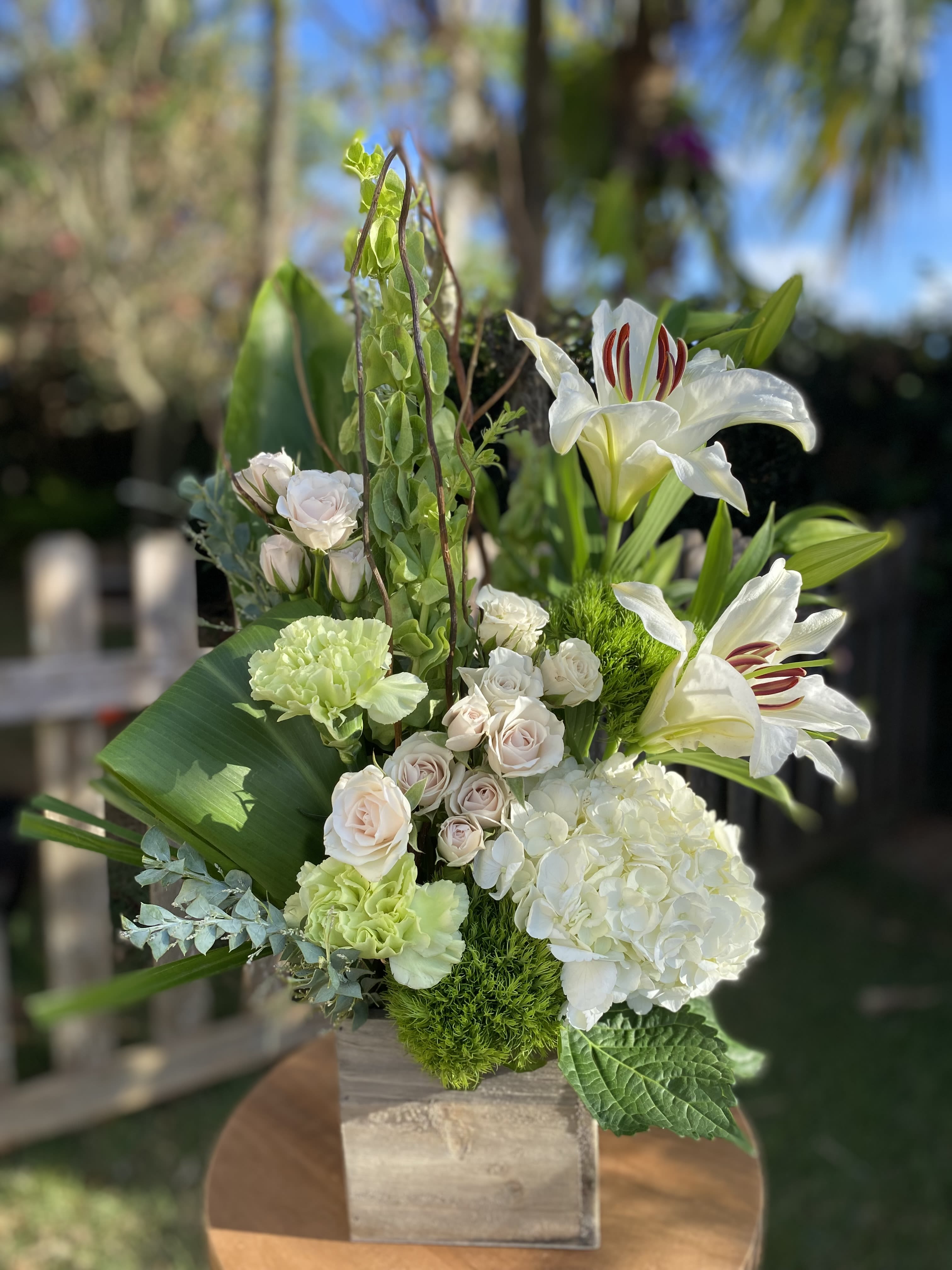 Designers Choice Neutral - Lilies, carnations and roses creating the most fragrant gift!  We will design a beautiful arrangement similar to photo based on seasonal blooms. 