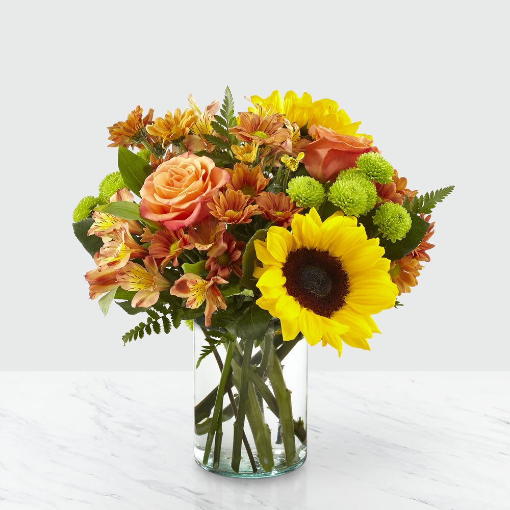 The FTD® Autumn Splendor® Bouquet - Say hello to autumn with this bouquet filled with bold harvest hues and luscious blooms. Thoughtfully arranged with the freshness of fall in mind, a collection of orange roses, bright sunflowers and orange alstroemeria is set beautifully in a clear glass vase. Whether it's seasonal décor for your home or a gift for a loved one, our Autumn Splendor Bouquet is sure to make any home its placed in feel warm and bright. Bouquet sizes are approximate.
