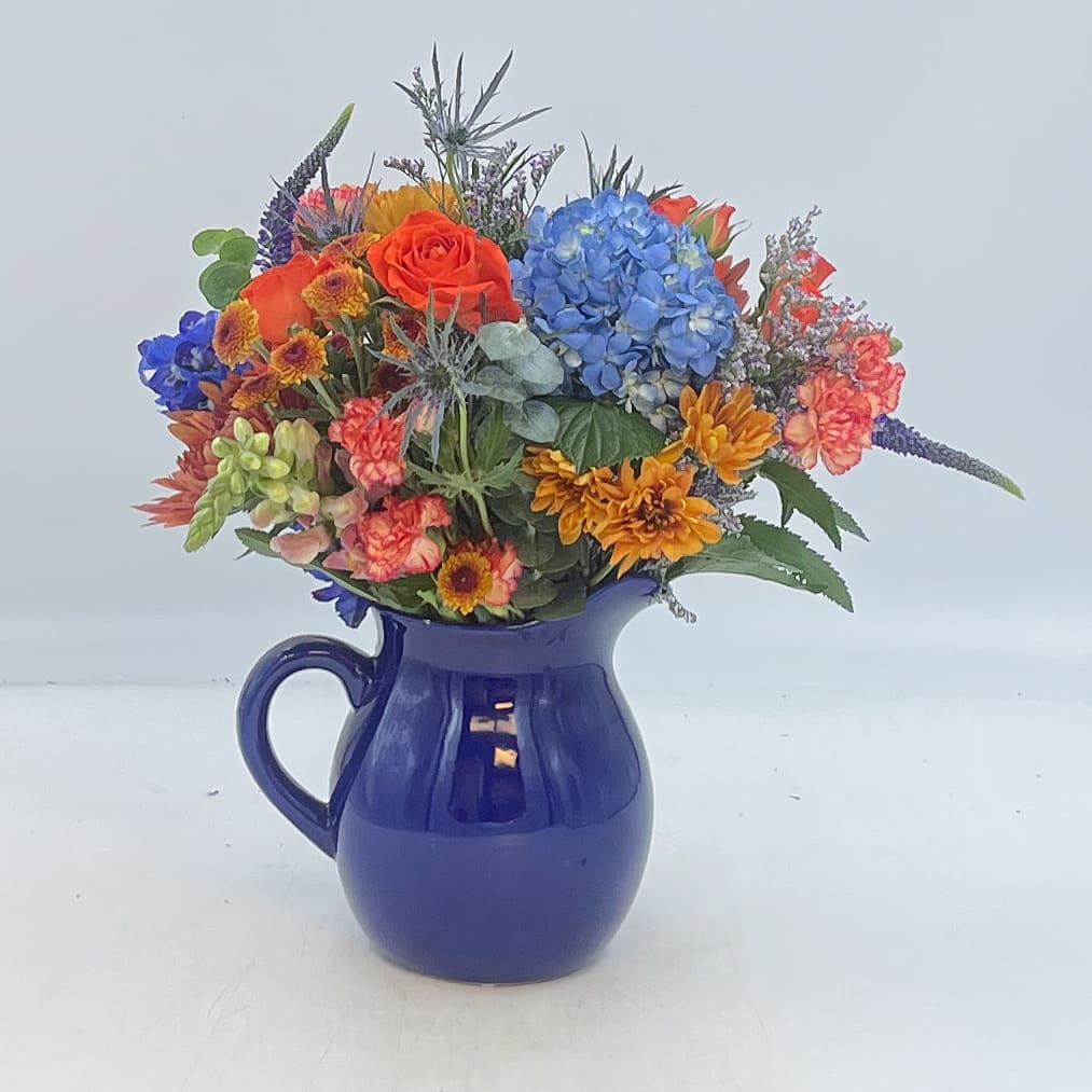 October Skies - October Skies is a mix of blue and bronze florals in a keepsake ceramic blue pitcher.