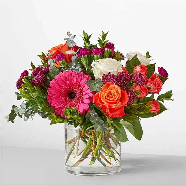 Smell the Roses Bouquet Smell the Roses Bouquet - Whether you are celebrating a milestone or simply wishing well, these hot pink and striking orange florals will be a reminder of nature's beauty. Details The Premium Bouquet is approximately 13"H x 18"W. Designed by florists, ready to display. For long–lasting blooms, replace the water daily. We suggest trimming the stems every couple days. Pet Safety Precautions: This bouquet or plant may include flowers and foliage that are known to be toxic to pets. To keep them safe, be sure to keep this arrangement out of your pet's reach. Bloom Details Rose Gerbera Daisy Eucalyptus Carnation