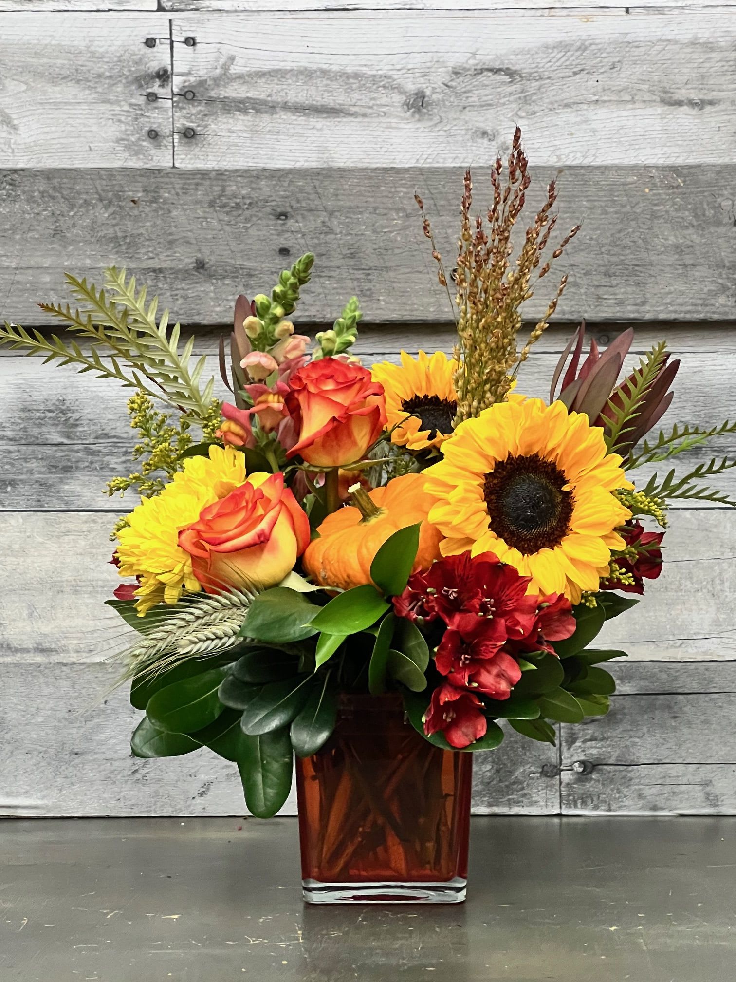 Pumpkin Patch  - An ensemble of beautiful fall flowers with the mini pumpkin. 