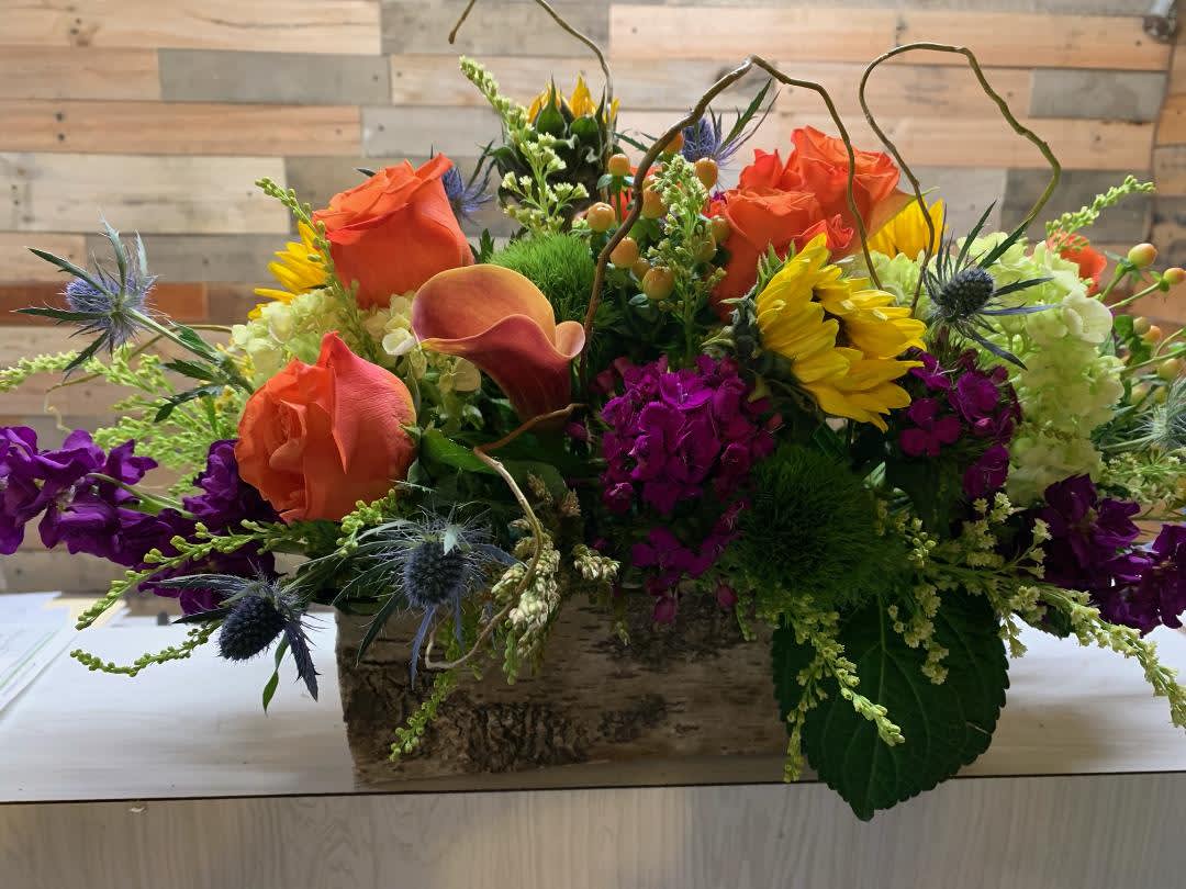 Box Beauty - This wooden box is filled with a variety of colors and textures to make this the perfect gift for your special someone.  Some flowers you might see in this arrangement will be roses, stock, calla lily, carnations and hydrangeas and many more!! Flowers depend on availability