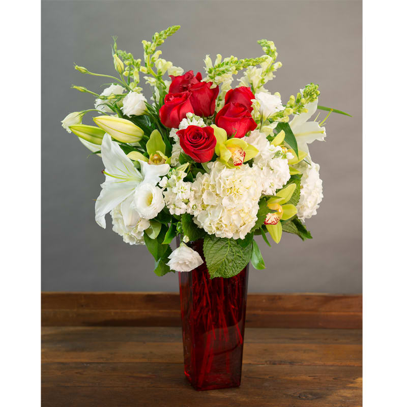 MY ONLY LOVE - LILIES,  HYDRANGEAS, CYMBIDIUM ORCHIDS, SNAP DRAGONS, LISIATNHUS IN A  TALL RED GLASS VASE