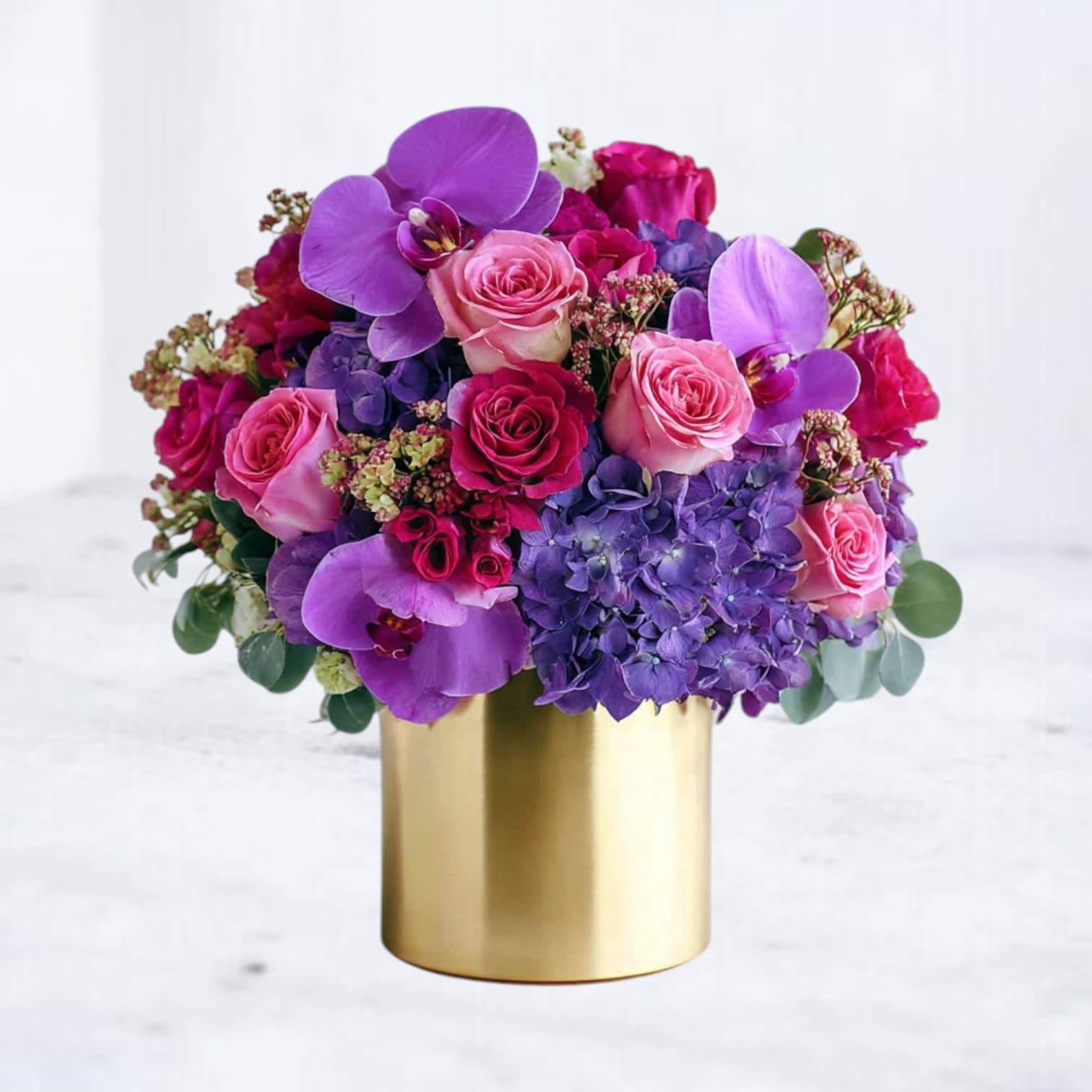 Royal Amethyst Bouquet Royal Amethyst Bouquet - Indulge in the luxury of the Royal Amethyst Bouquet, an opulent arrangement featuring vibrant purple orchids, lush hydrangeas, deep red roses, and delicate pink spray roses. Designed in a sleek gold vase, this bouquet exudes regal elegance and sophistication, perfect for celebrating milestones, anniversaries, or any occasion that calls for grandeur. Available for same-day delivery in Houston and surrounding areas, the Royal Amethyst Bouquet is a statement of timeless beauty and splendor.