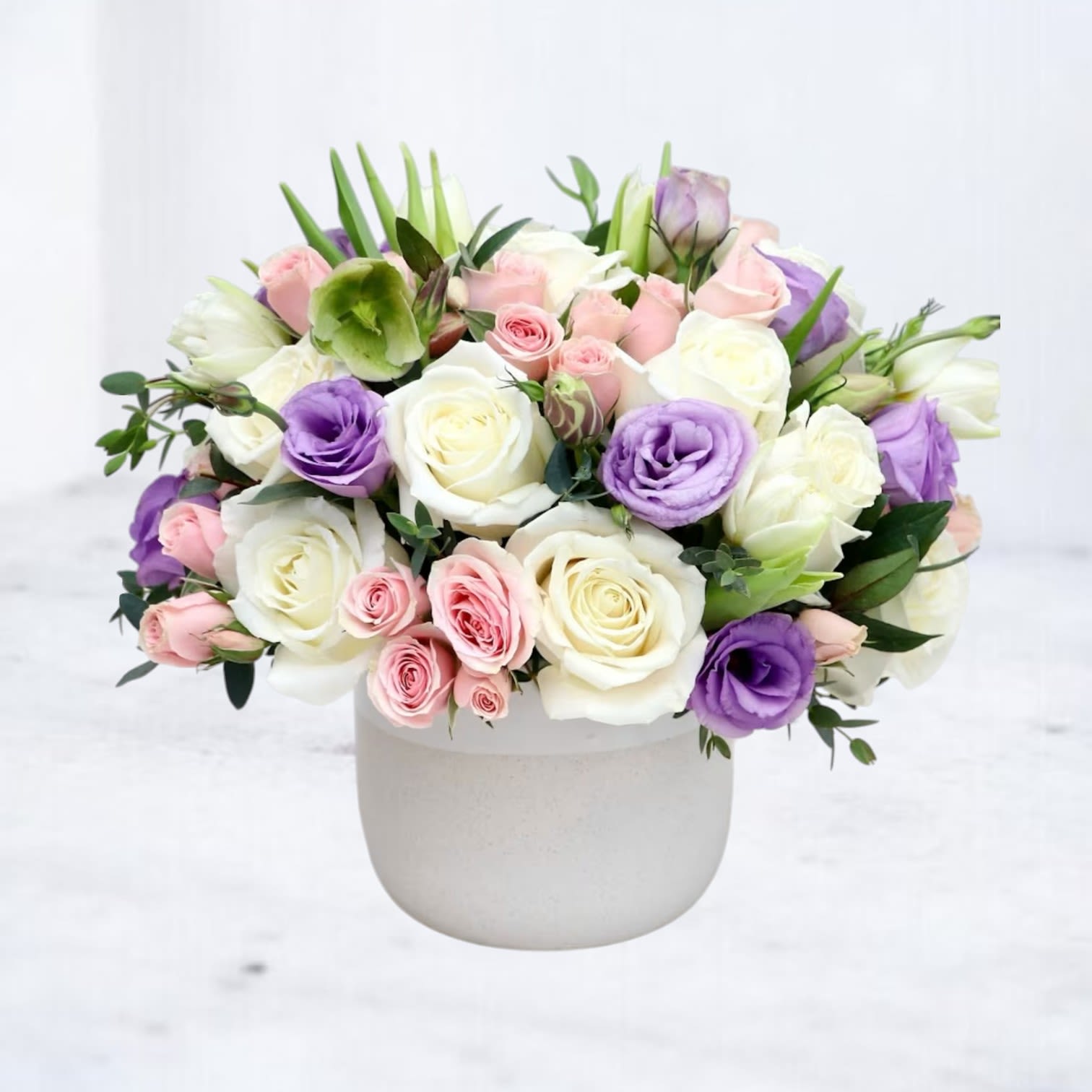 Pastel Prism Pastel Prism - Delicate yet impactful, Pastel Prism brings together soft ivory, blush pink, and lavender tones in a dreamy floral palette. This lush design features premium white and pink roses, pale lisianthus, and tulips—accented with seasonal greenery and a pop of helleborus for depth. It’s graceful, elevated, and made to impress—perfect for Mother’s Day, baby showers, or simply sending a little luxury to someone’s day. Please note: Helleborus is seasonal and may be substituted with a comparable flower based on availability.