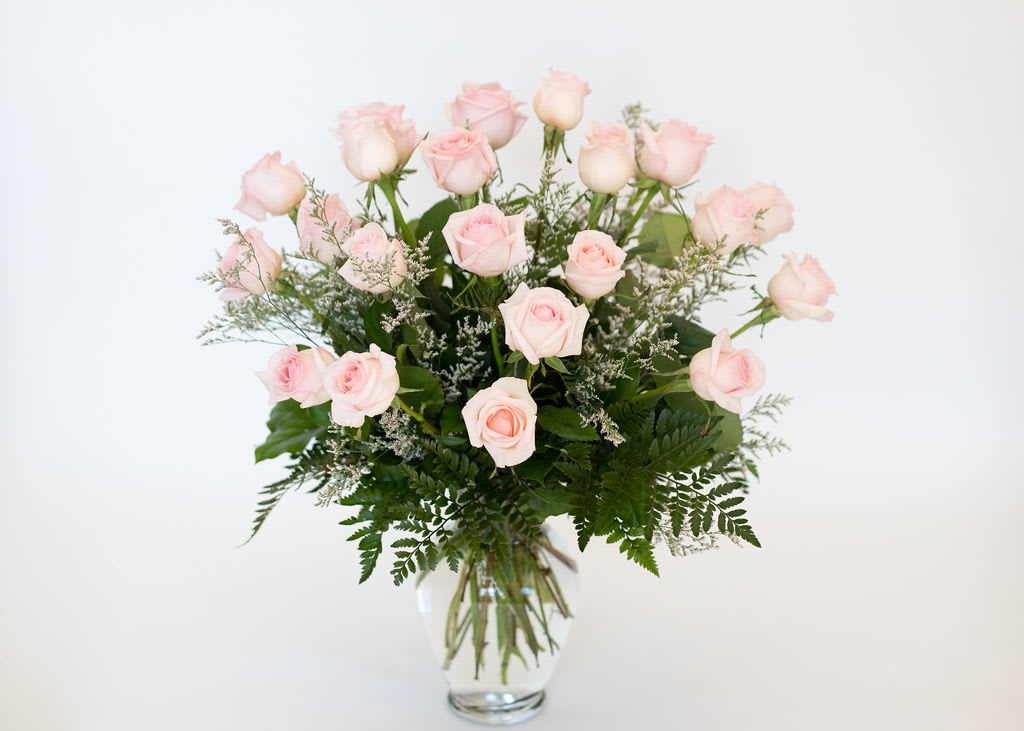 Two Dozen Roses in Pink  - A stunning and dramatic display of expertly arrangement long-stemmed roses nestled among beautiful greenery and accent flowers. A sweet grand gesture for that special someone! Arrangement is approximately 24&quot; tall and 16' wide. 