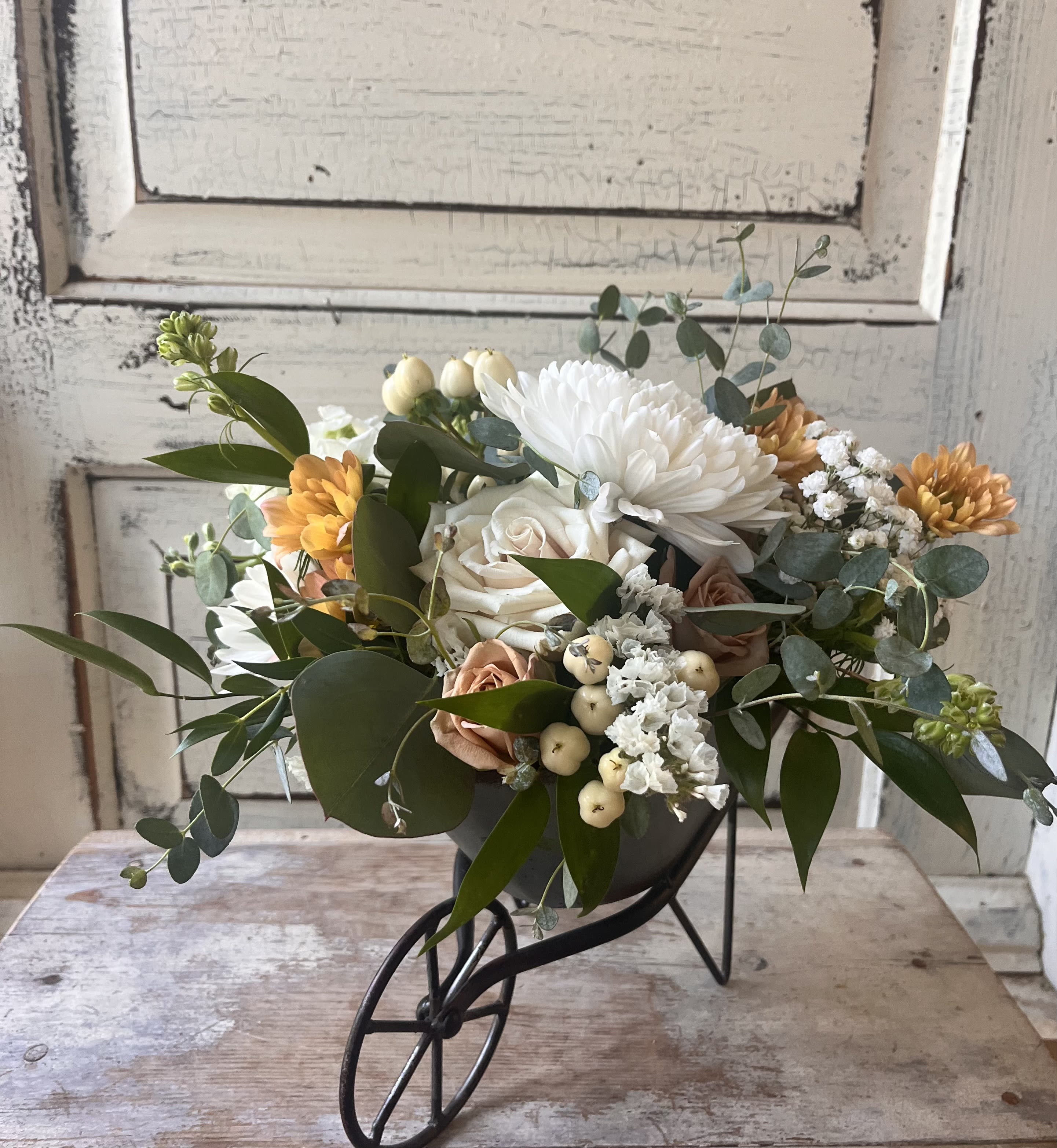 Farm Fresh  - Seasonal flowers are arranged in a mini metal wheel barrel. Colors and flowers will vary week to week based on our inventory but the arrangement is always unique and fresh.