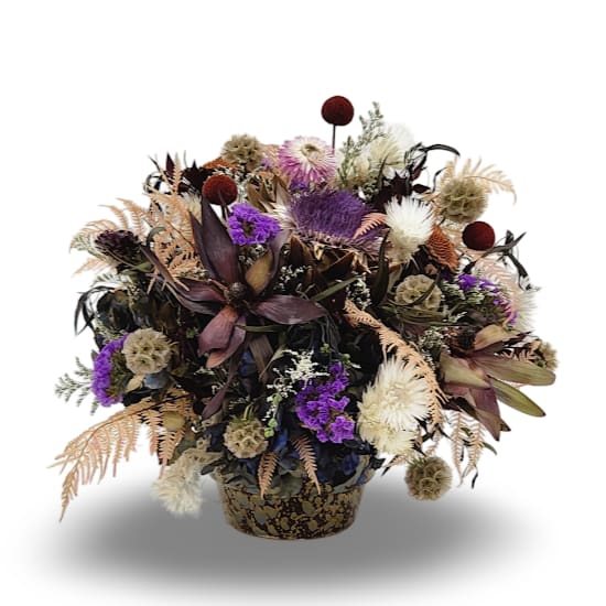 Dried Garden Dried Garden - Preserved Beauty is a medium sized dried arrangement with a playful one sided design. Featuring a soft mix of white, blush pink, and gentle yellow tones, it brings a light and airy feel to any space with the natural charm of everlasting blooms.