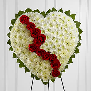The FTD Broken Heart The FTD Broken Heart - The FTD® Broken Heart™ is a beautiful way to express the impact that the departed had on your life. Pearly white chrsyanthemums form the shape of a heart accented with greens lined around the outside and "broken" in the middle with a line of rich red roses to create an exqusite way to honor the life of the deceased at their memorial service. Displayed on a wire easel.