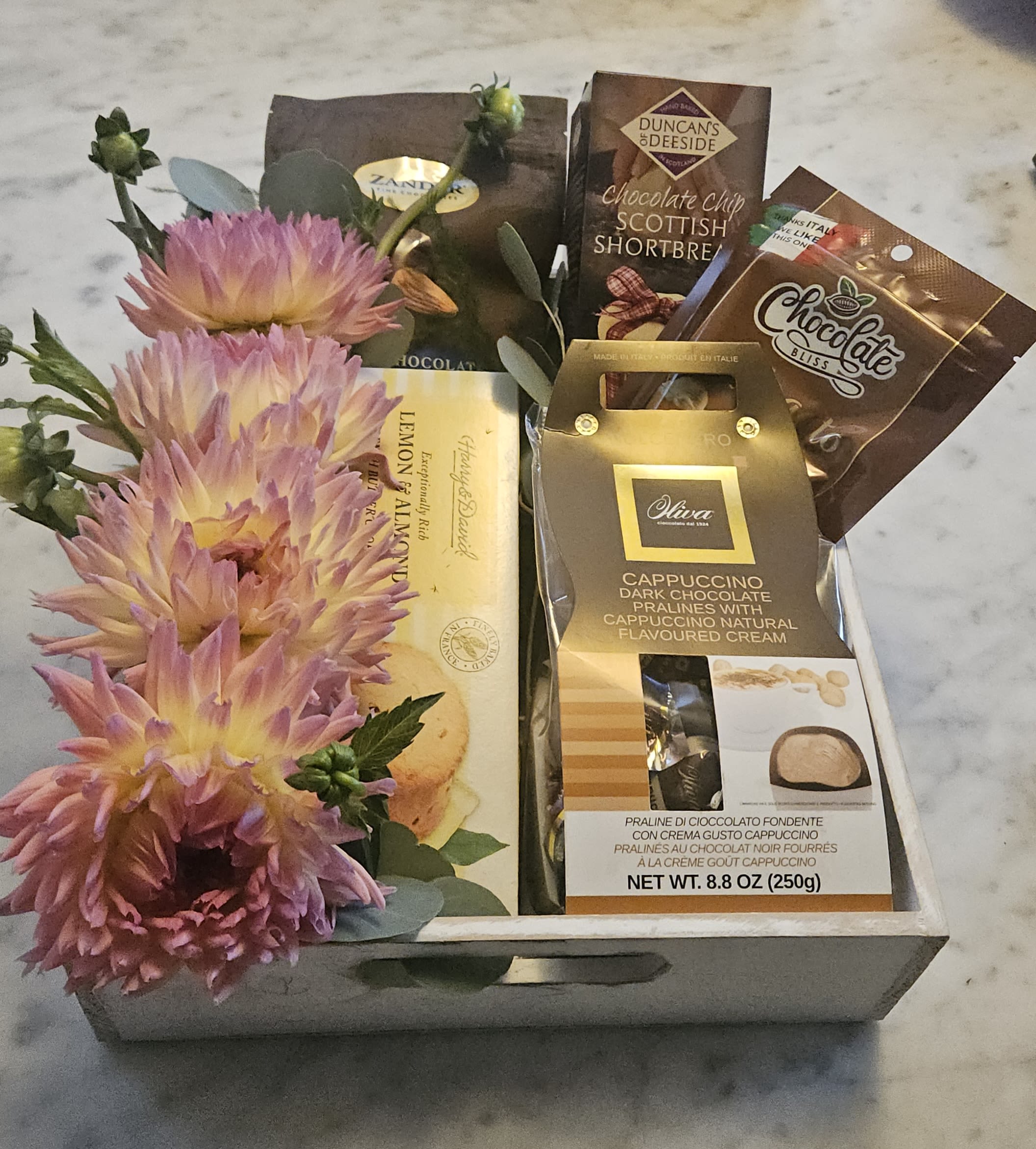 Gift Basket - A beautiful wooden box assorted with tasty chocolates, crackers and seasonal fruits or flowers.