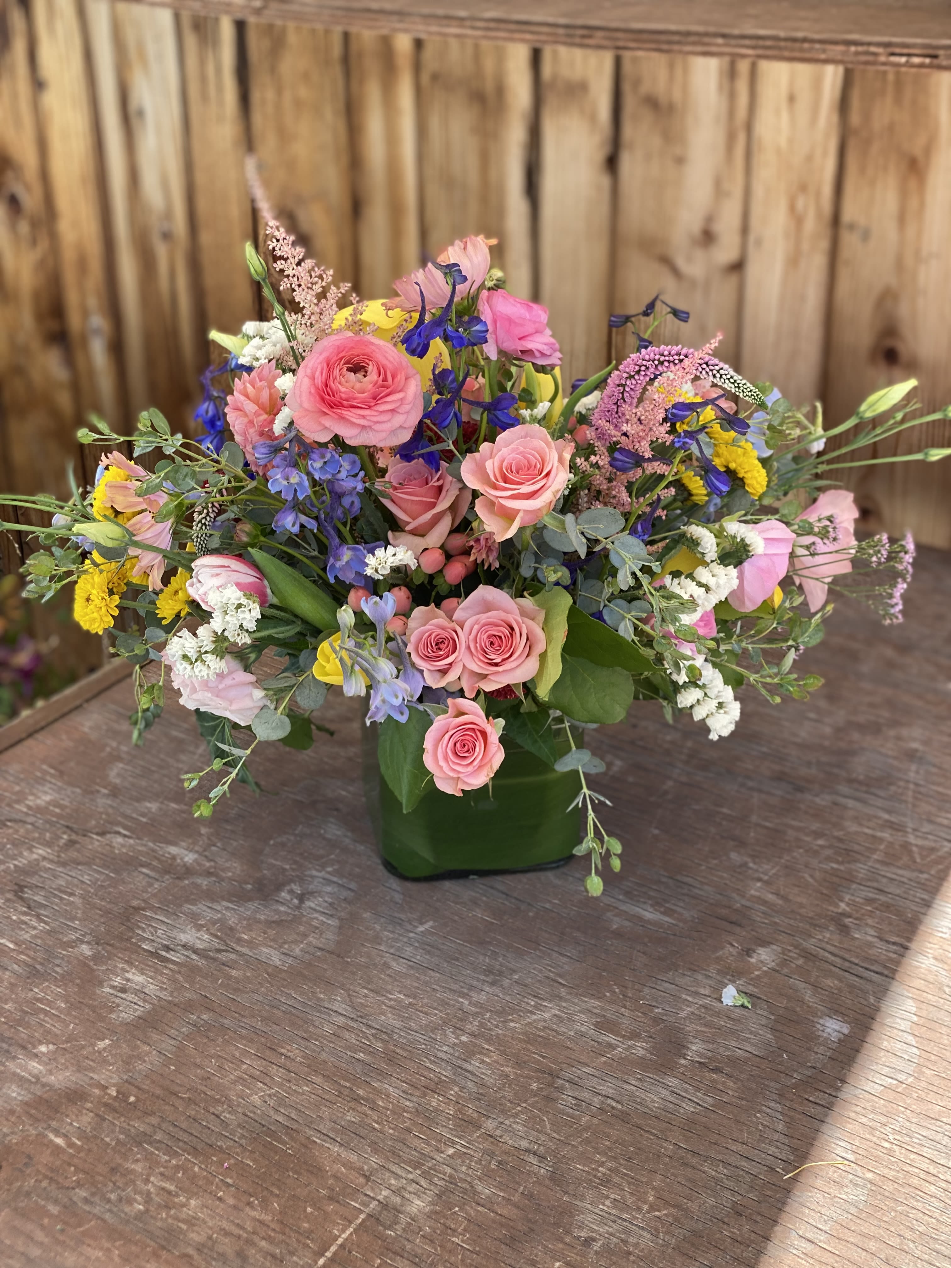 Pink cloud  - An arrangement of in season pink, yellow and touches of blue blooms. Comes in glass vase 