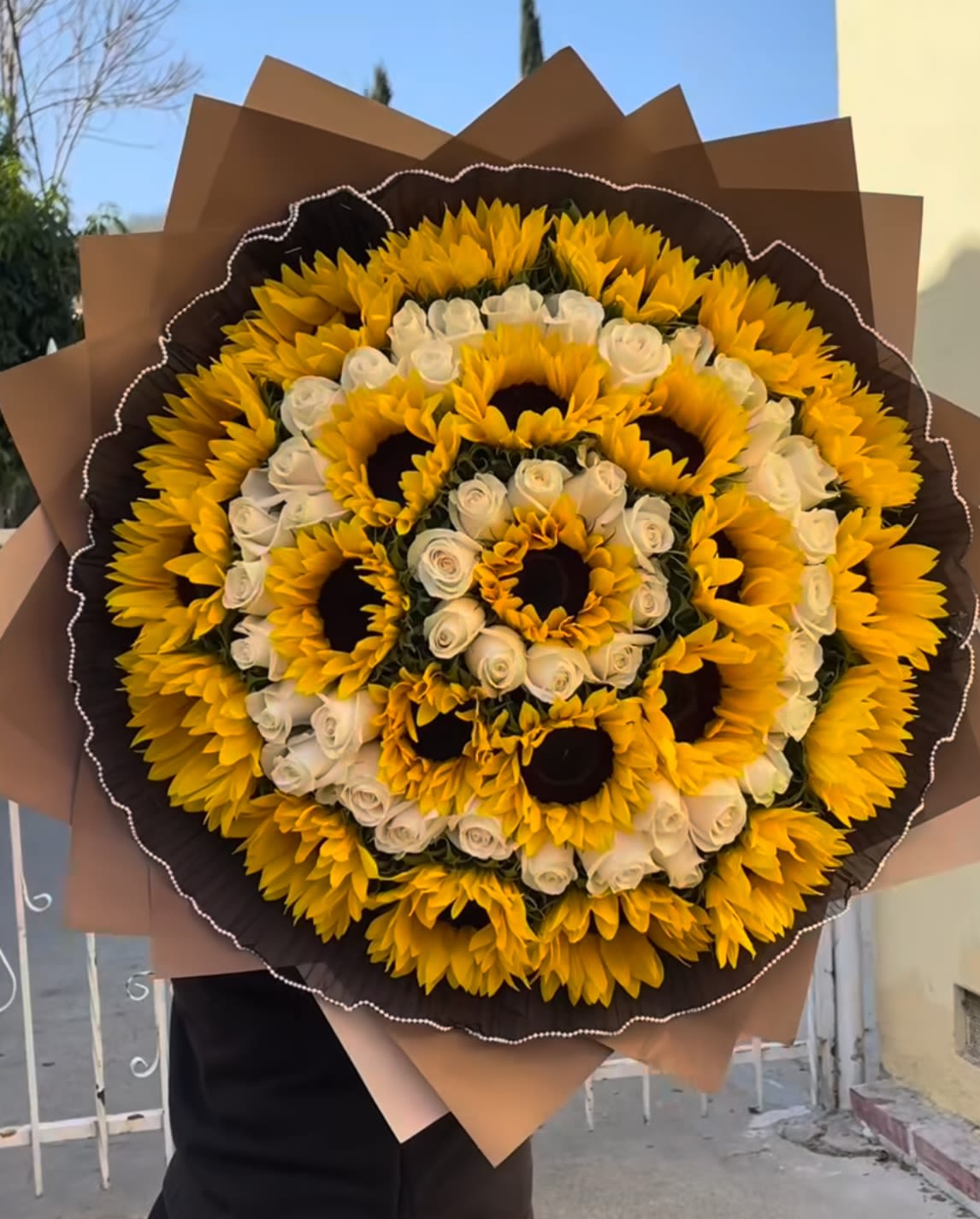 Sunflowers and roses bouquet  - Sunflowers represent joy, positivity, vitality and optimism, due to their bright color and their association with the sun. They symbolize loyalty, admiration and devotion, as the flower follows the movement of the sun. Available every day.