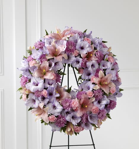 The FTD Sleep in Peace Wreath The FTD Sleep in Peace Wreath - The FTD® Sleep in Peace™ Wreath is a soft expression of sympathy that will bring comfort and offer hope during the final farewell. Lavender gladiolus pink Asiatic lilies lavender chrysanthemums pink mini carnations and lush greens are beautifully arranged in the form of a wreath for a sweet and colorful look. Displayed on a wire easel this wreath is a lovely way to honor the life of the deceased.