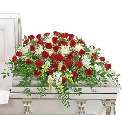 Serene Funeral Casket Spray - A beautiful casket spray with red roses, red carnations, hydrangea, snapdragons, stock, with lush greenery to finish it off. 