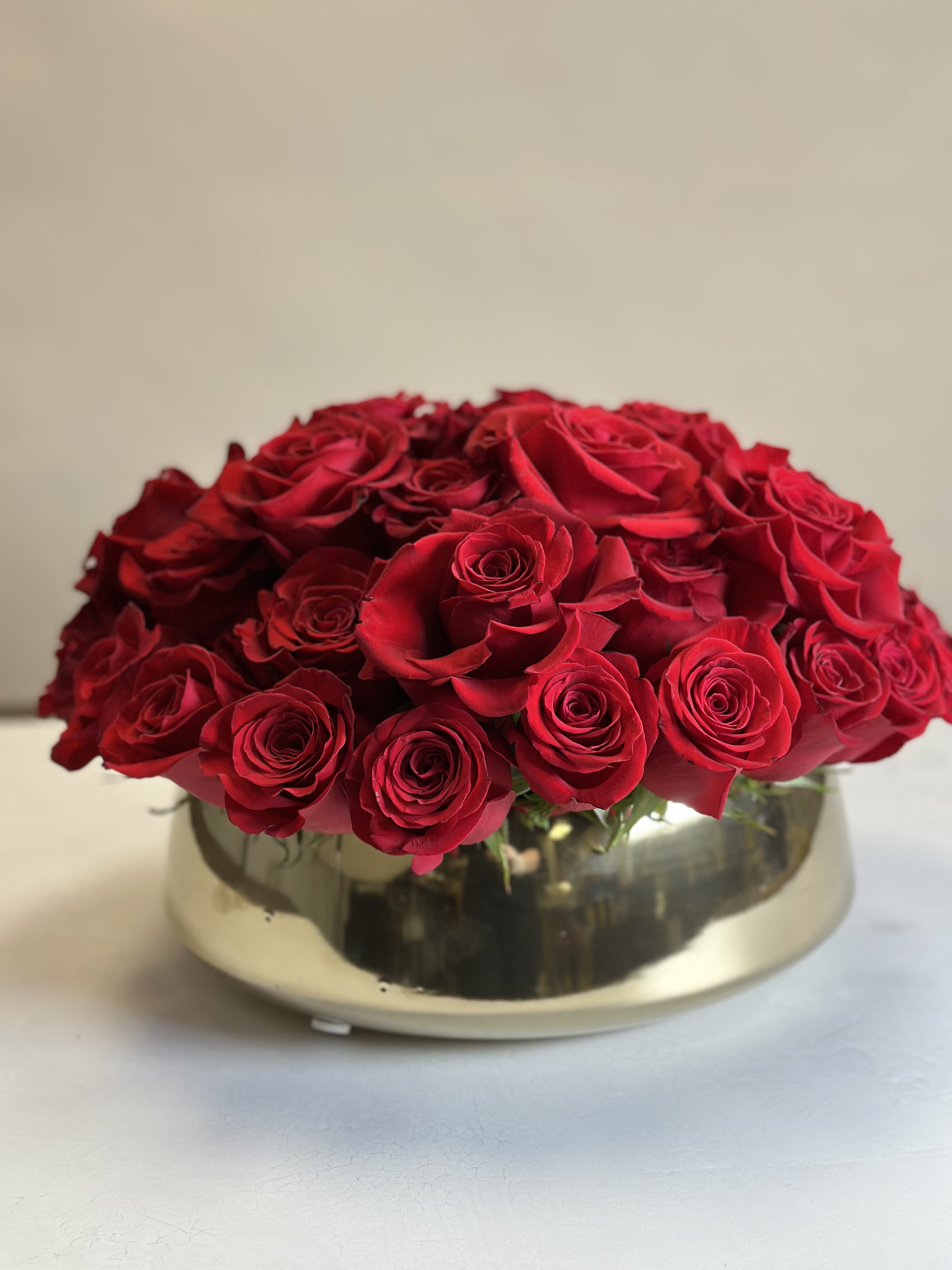 Luxury  - A stunning modern display of 55 red roses, arranged in an elegant ceramic vase. A true symbol of love and devotion, perfect for celebrating life's most heartfelt moments.