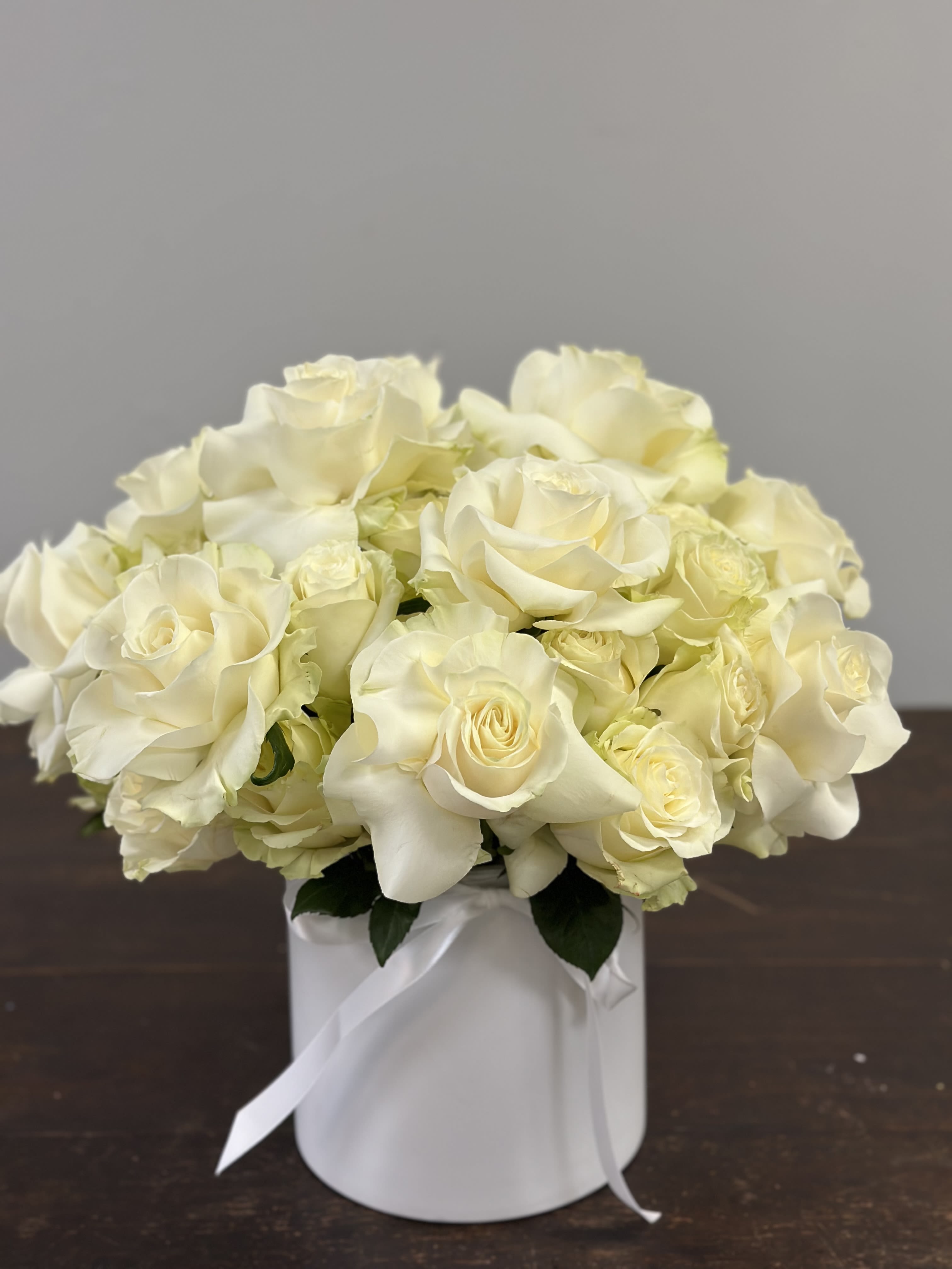 Bella  - Beautiful white French roses arranged with grace in a sleek ceramic vase. A refined and luxurious centerpiece ideal for home décor or as a thoughtful gift.