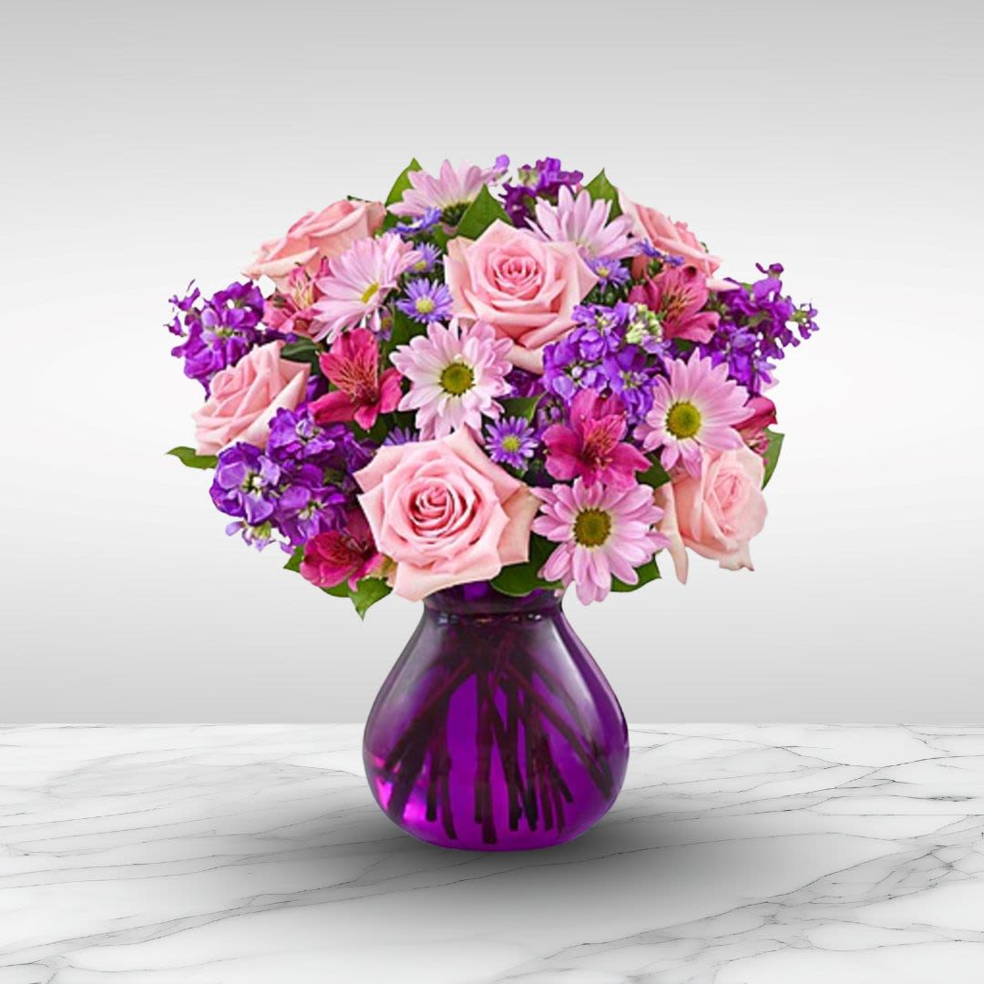 Beauty in Elegance - Truly a stunning gift, but without a stunning price tag. Recipe: Take their breath away with a spectacular array of pink roses, stargazer lilies, alstromerias, and carnations in a classic ginger jar in deep royal purple.  Seasonal: All year round Design View: All-sided Facing View Photo shown: Standard 