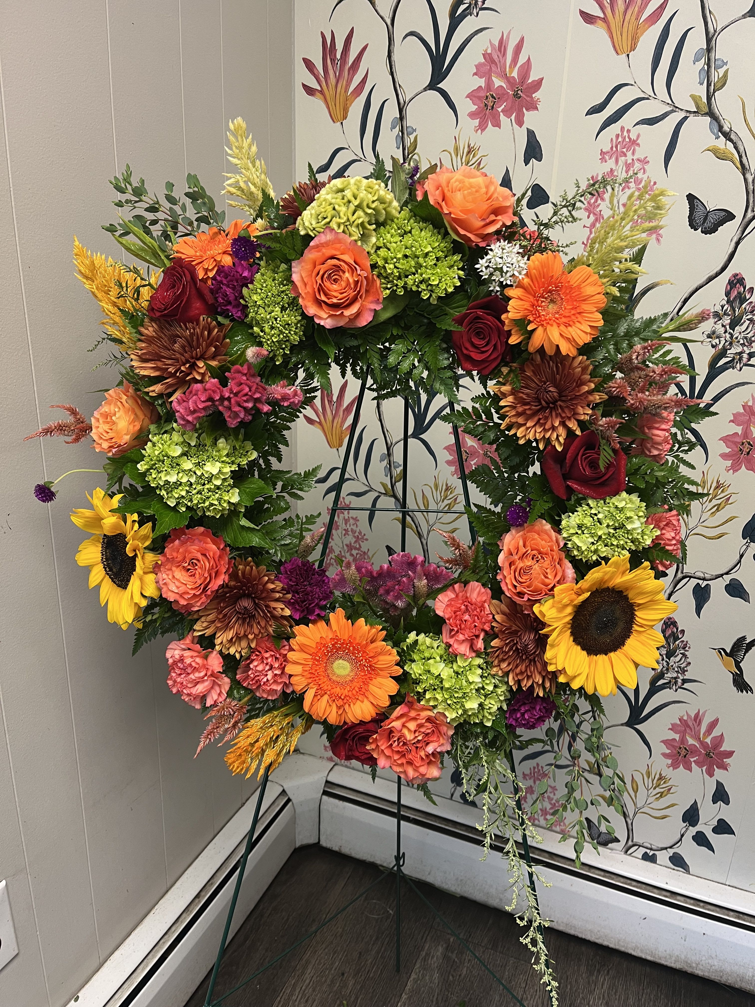 Fall memorial wreath.  - Designers choice of seasonal harvest colors arranged in a wreath to surround your loved one with a beautiful tribute.