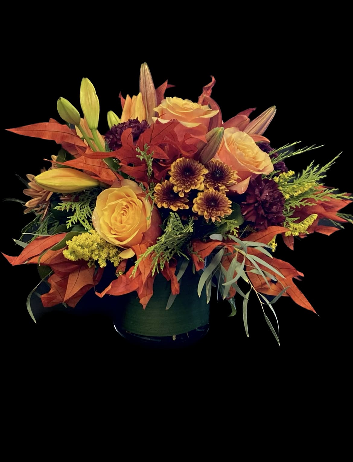 Autumn Splendor - A beautiful floral arrangement perfect for any occasion and/or the upcoming Fall Holiday.  Colors consist of deep reds, orange's, greens and yellows with Fall leaves.  An array of greens and florals are used and may vary slightly per arrangement.