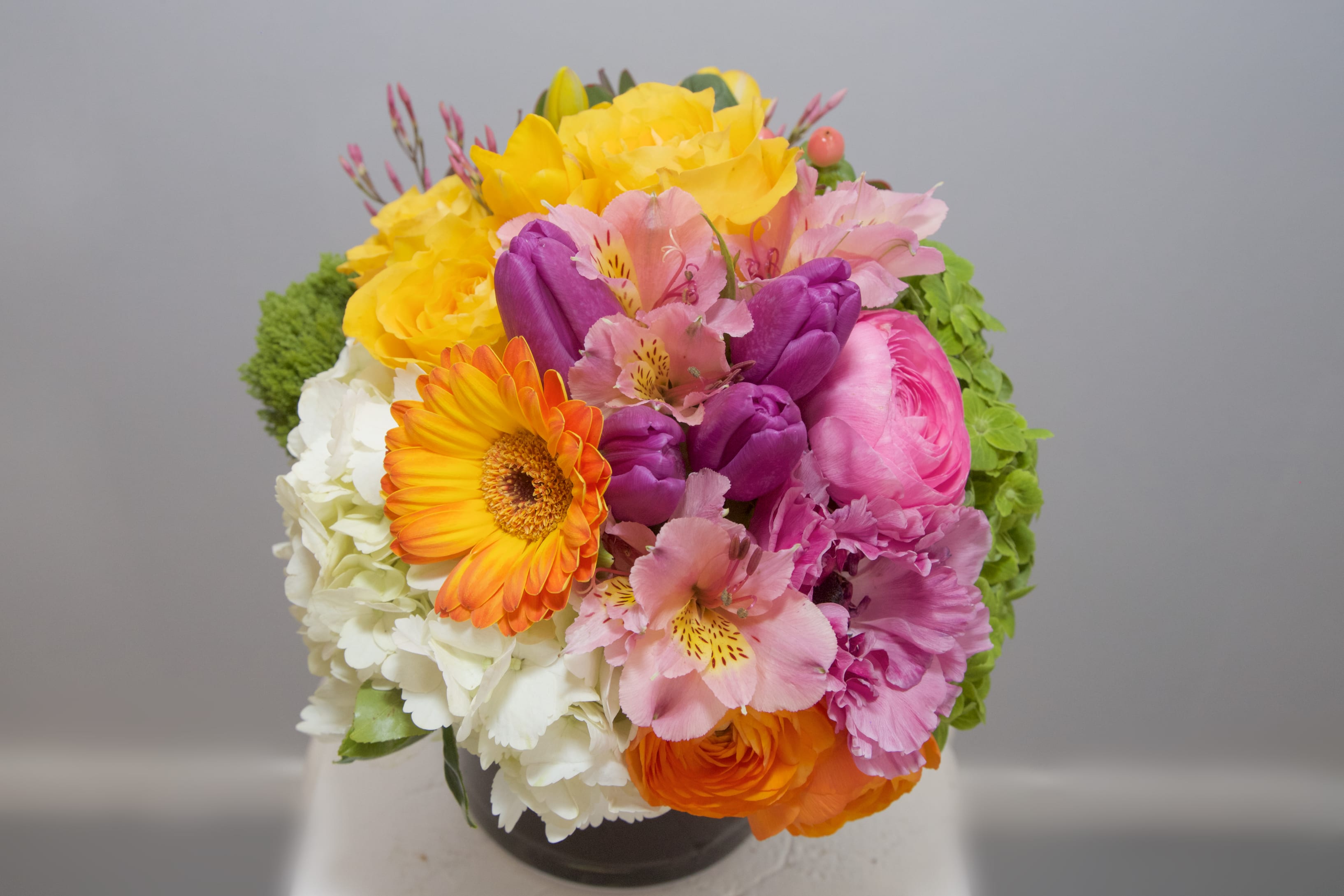 Baker Beach Beautiful - Delight your Beloveds with this bright, happy arrangement of Hydrangeas, Gerbera Dasies, Roses, Alstromeria, Tulips, Anemone...