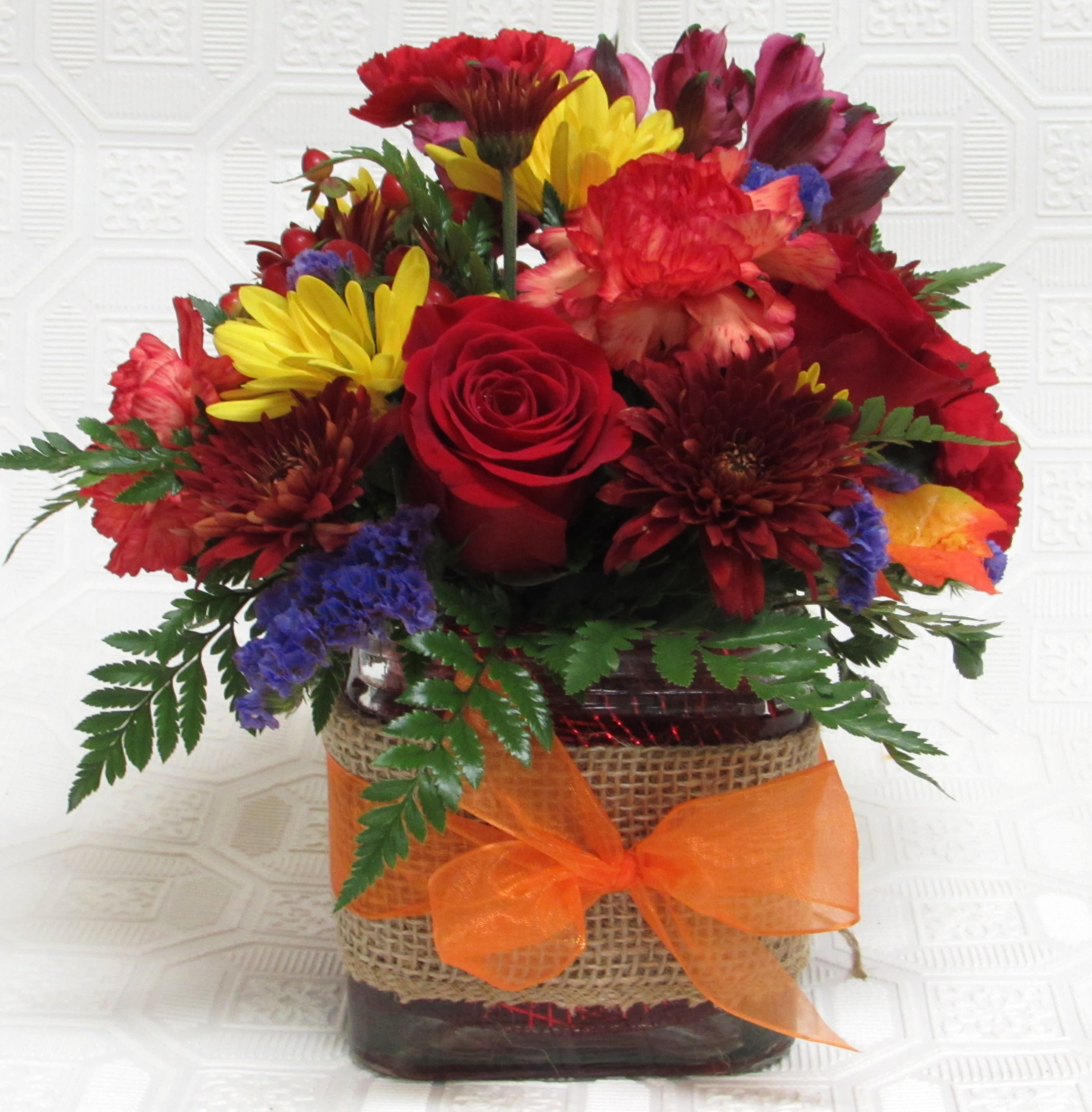 Falling For You  Autumn Bouquet - Glass cube w/ burlap and ribbon band.  Roses, seasonal colored mums, statice and carnations.  