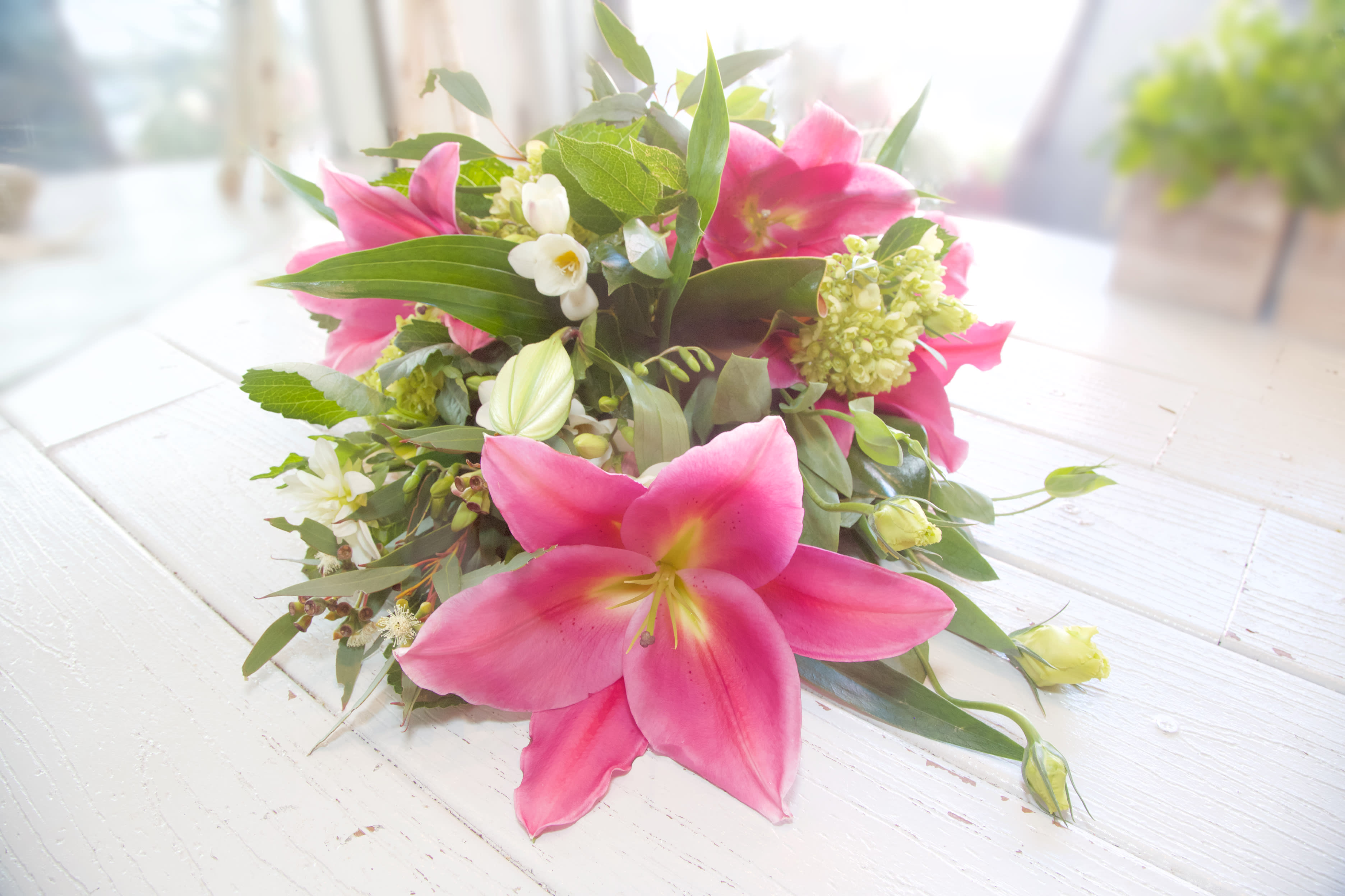 Embarcadero Embrace - Hug your Darling Dearest with this wrapped bouquet of Lilies, Magnolia Greens, Stock...really anything is possible for any occasion. Ask and you shall receive.